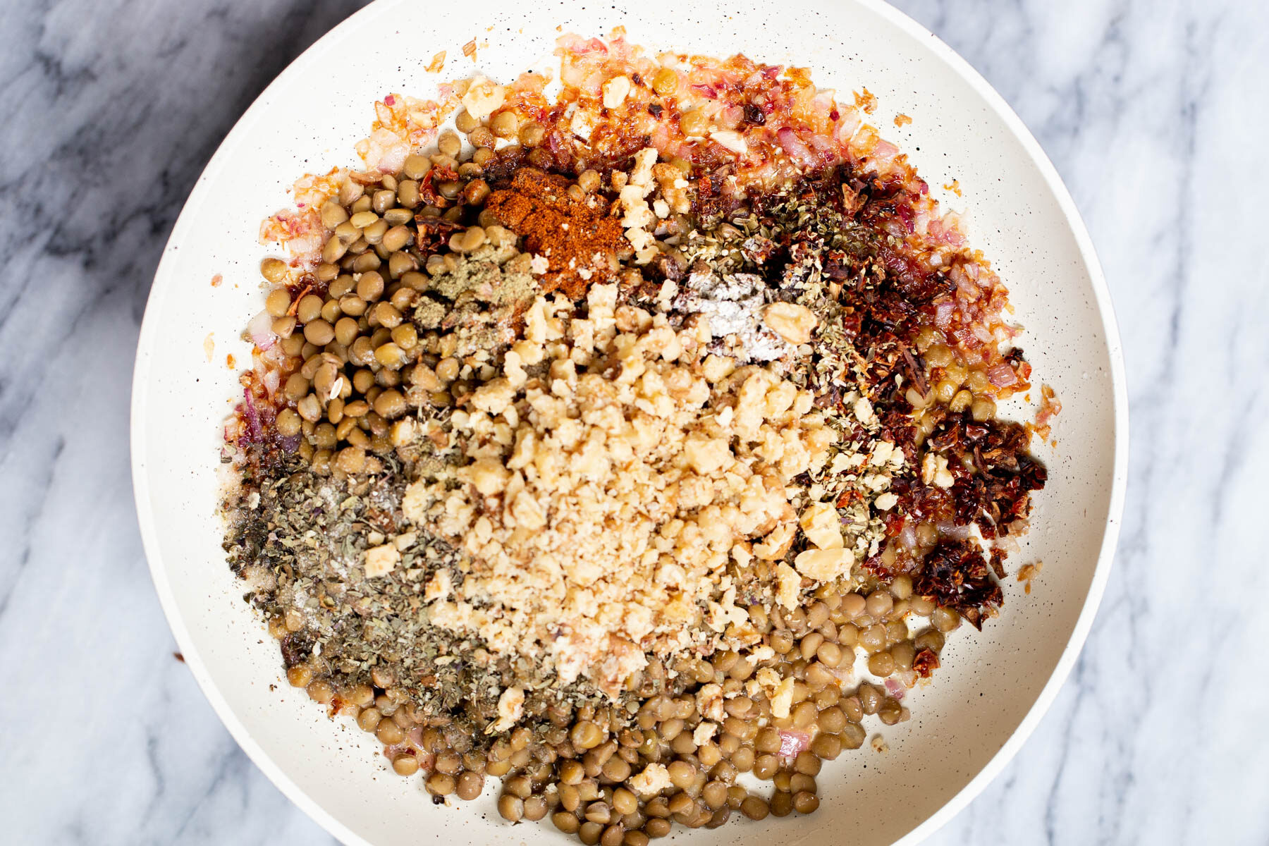 lentils and spices in a sauteeing pan 