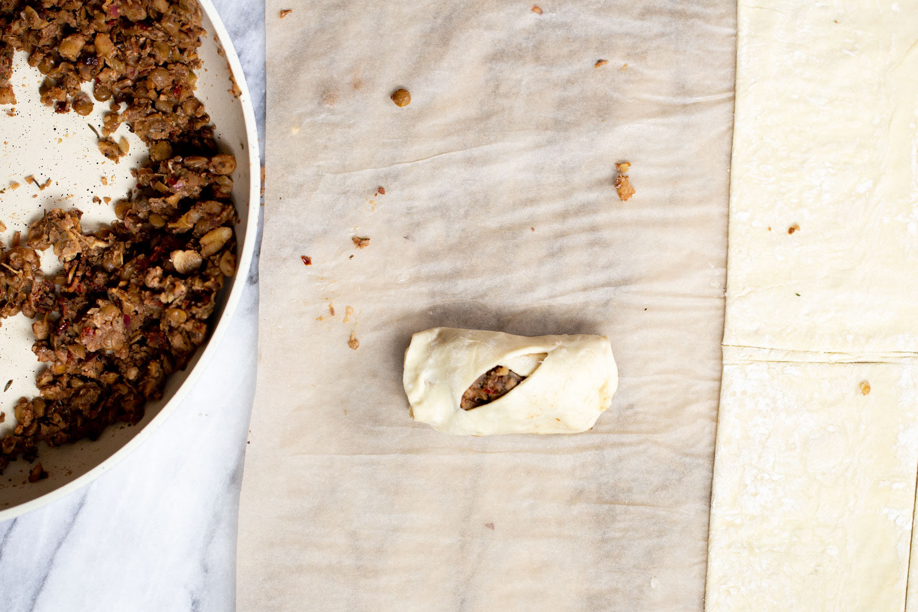 a vegan sausage roll on parchment paper