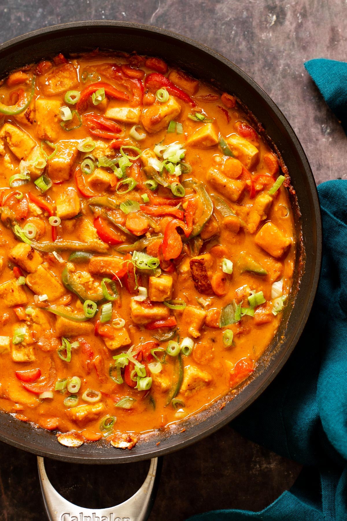a skillet with veggies and tofu cubes in creamy Korean stir-fry sauce