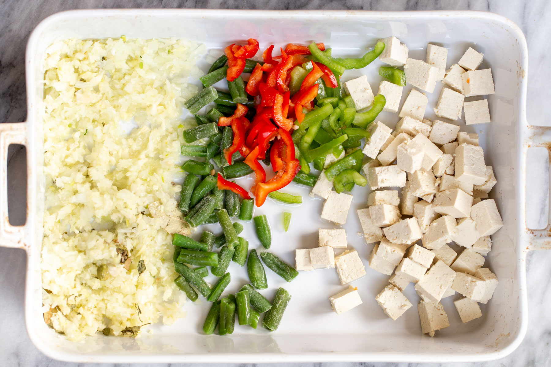 Navratan Korma  a casserole dish with ginger, garlic and chopped veg as well as tofu in a white casserole dish