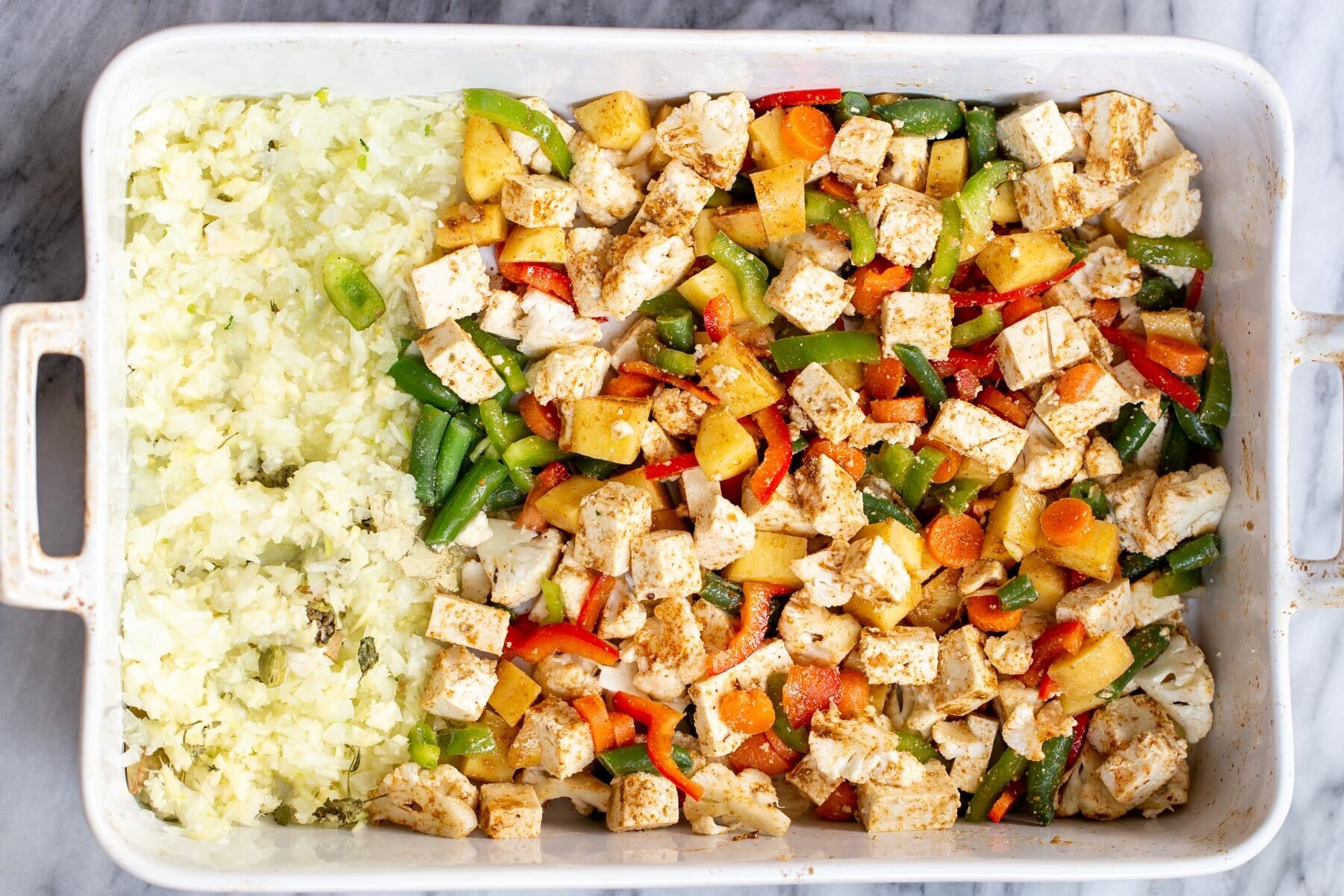 veggies and minced garlic and ginger in a white casserole dish