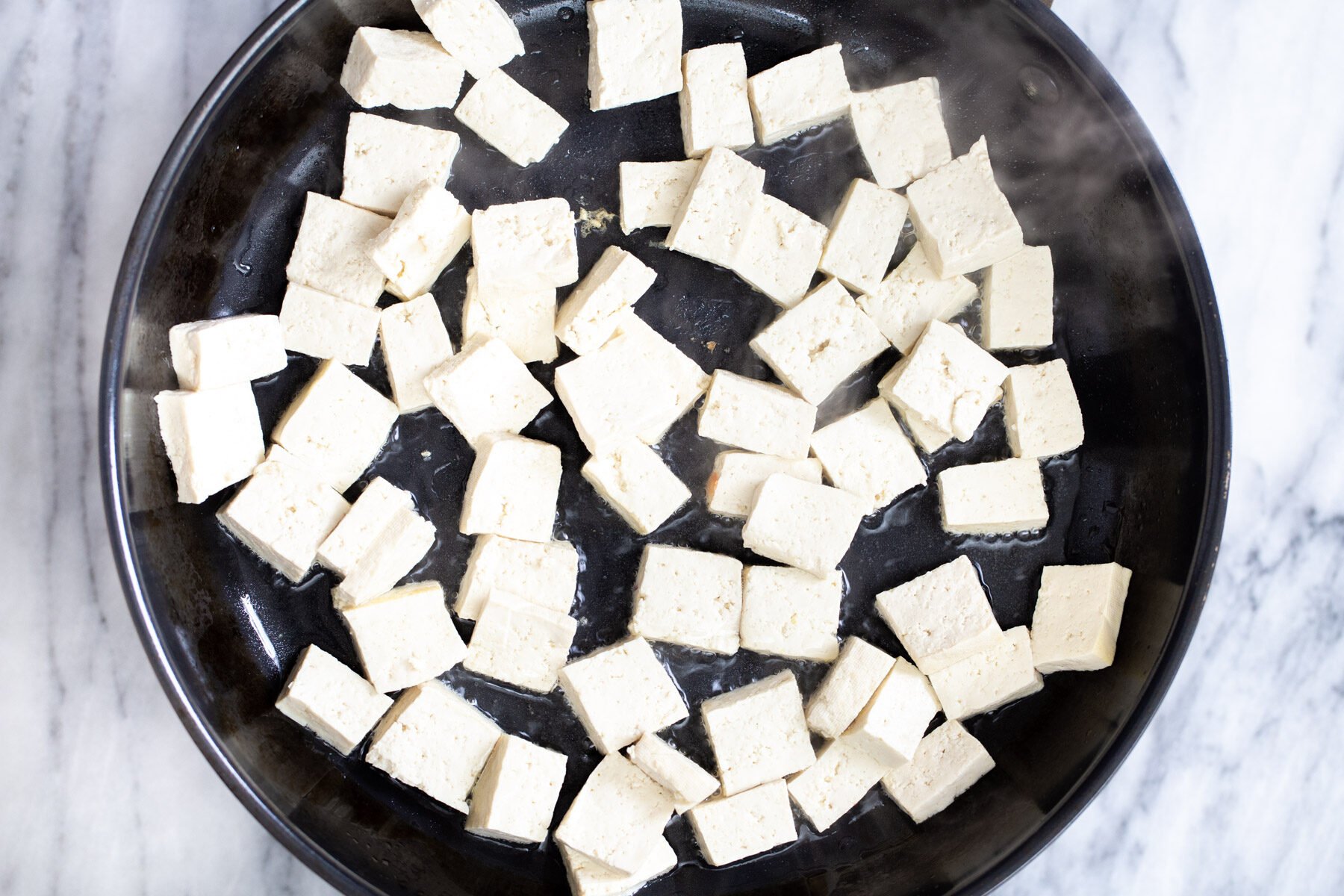 pressed tofu cubes in a frying pan