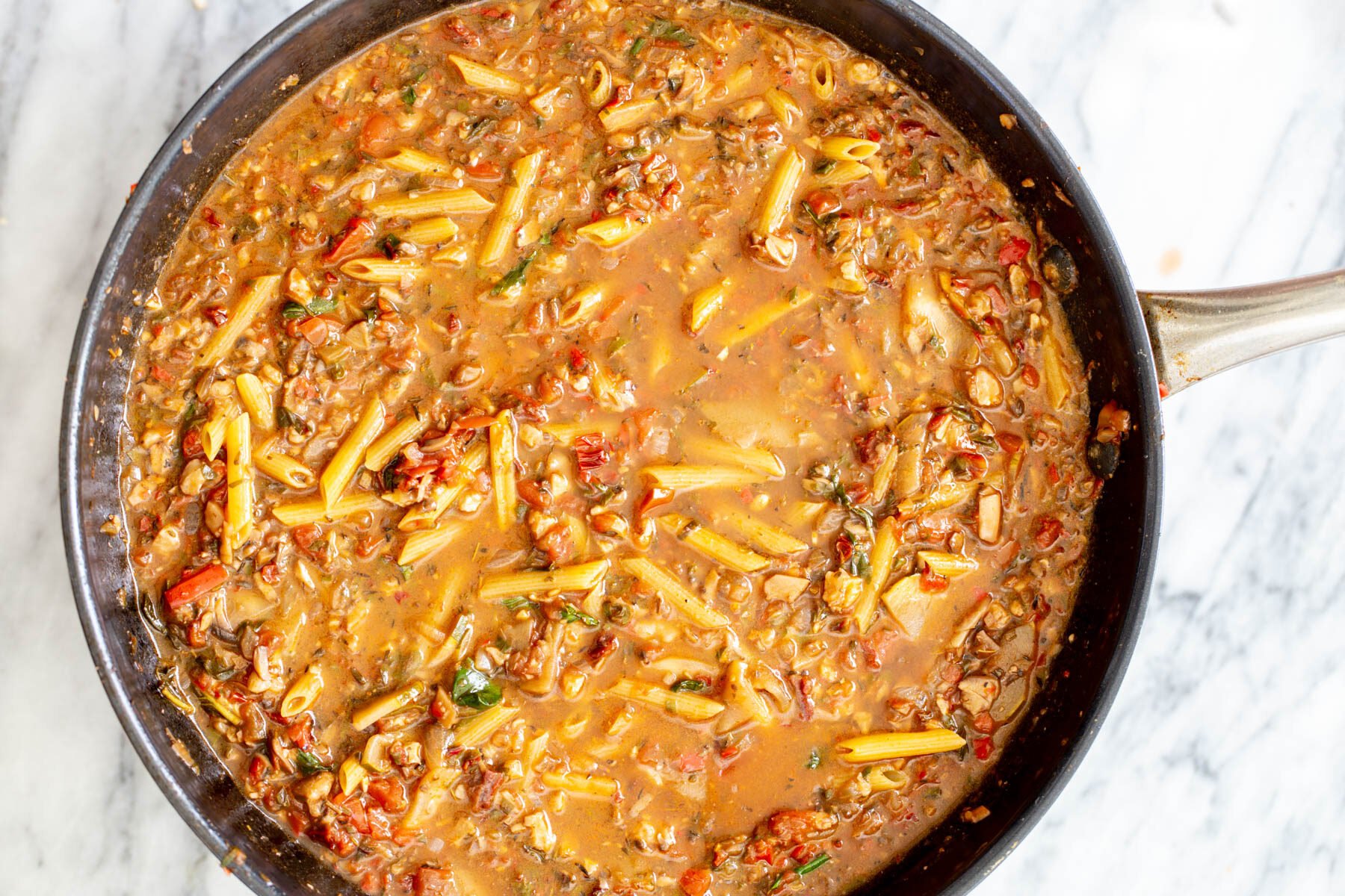 sauteeing pan with pasta and veggie ragu