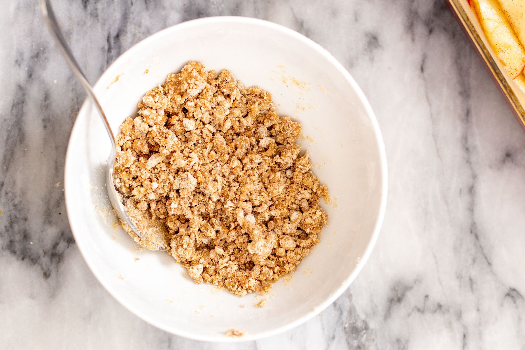 crumble topping for apple pie bars in a white bowl