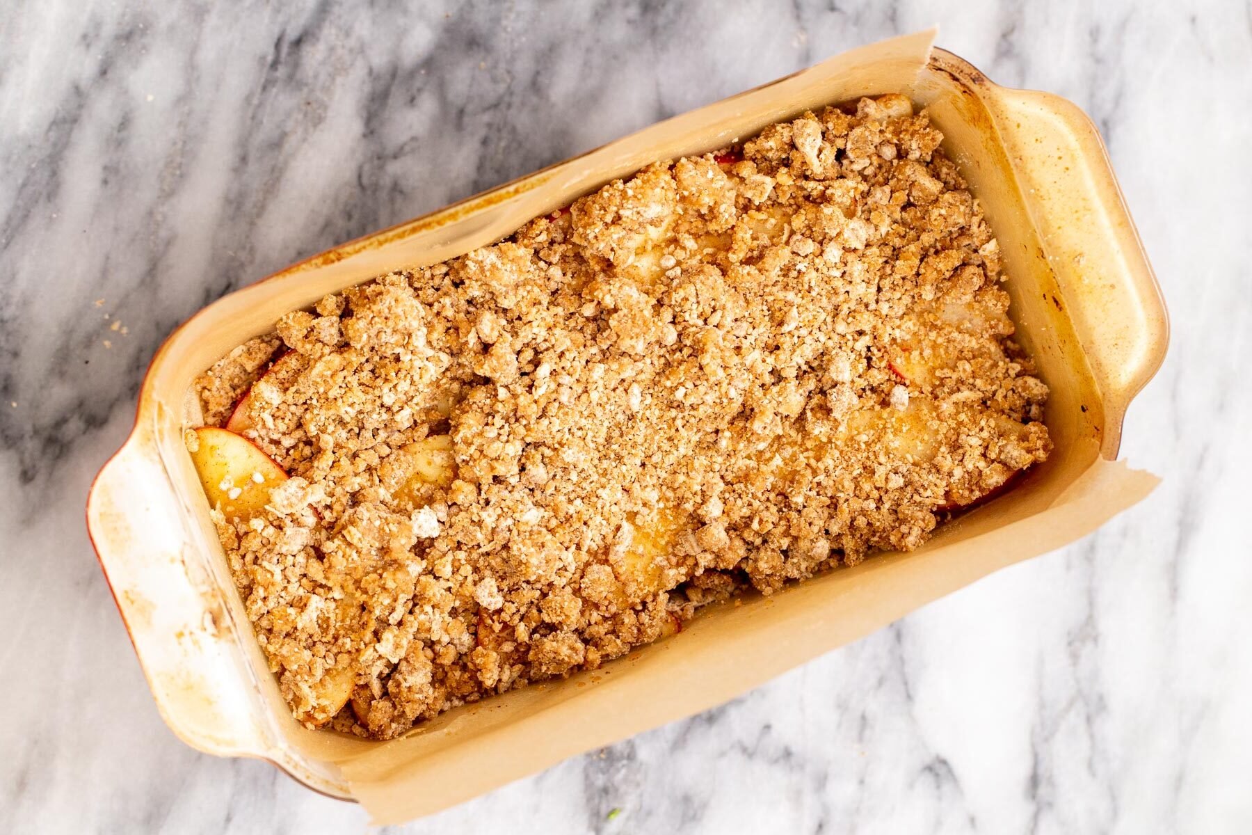 apple pie crumble bars in a baking pan