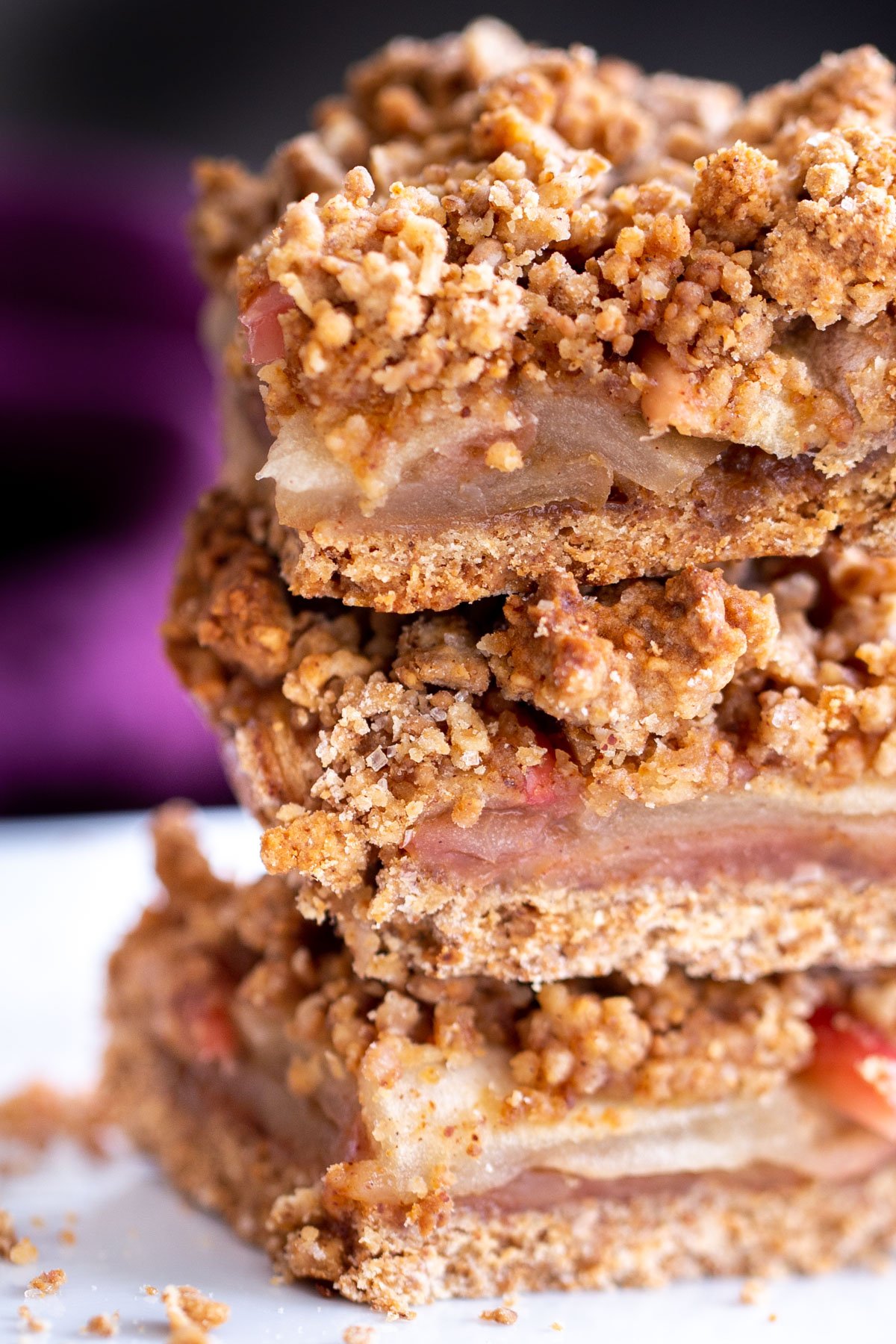 vegan apple pie crumble bars stacked on a plate