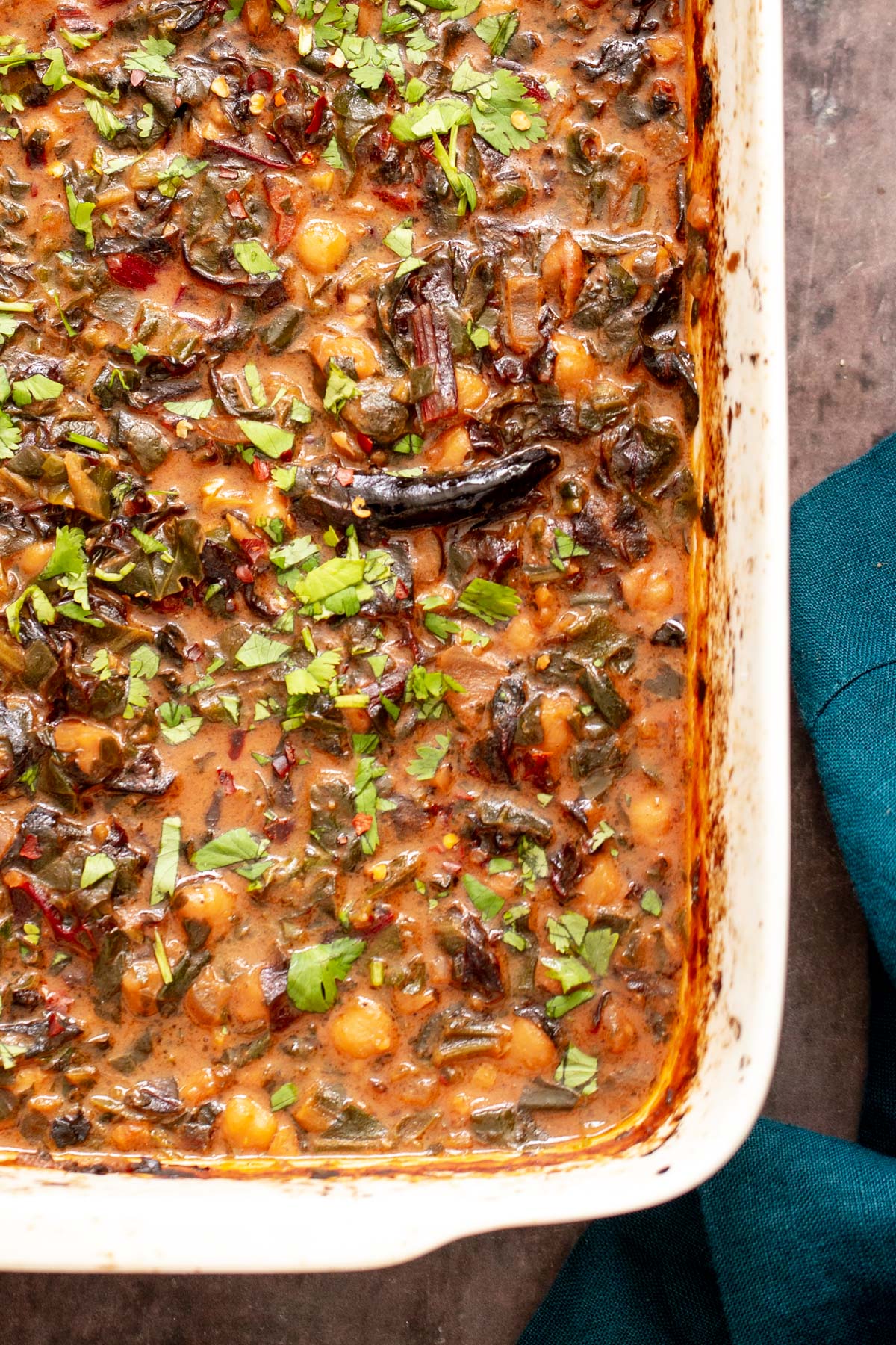 baked vegan chana saag in a white casserole dish
