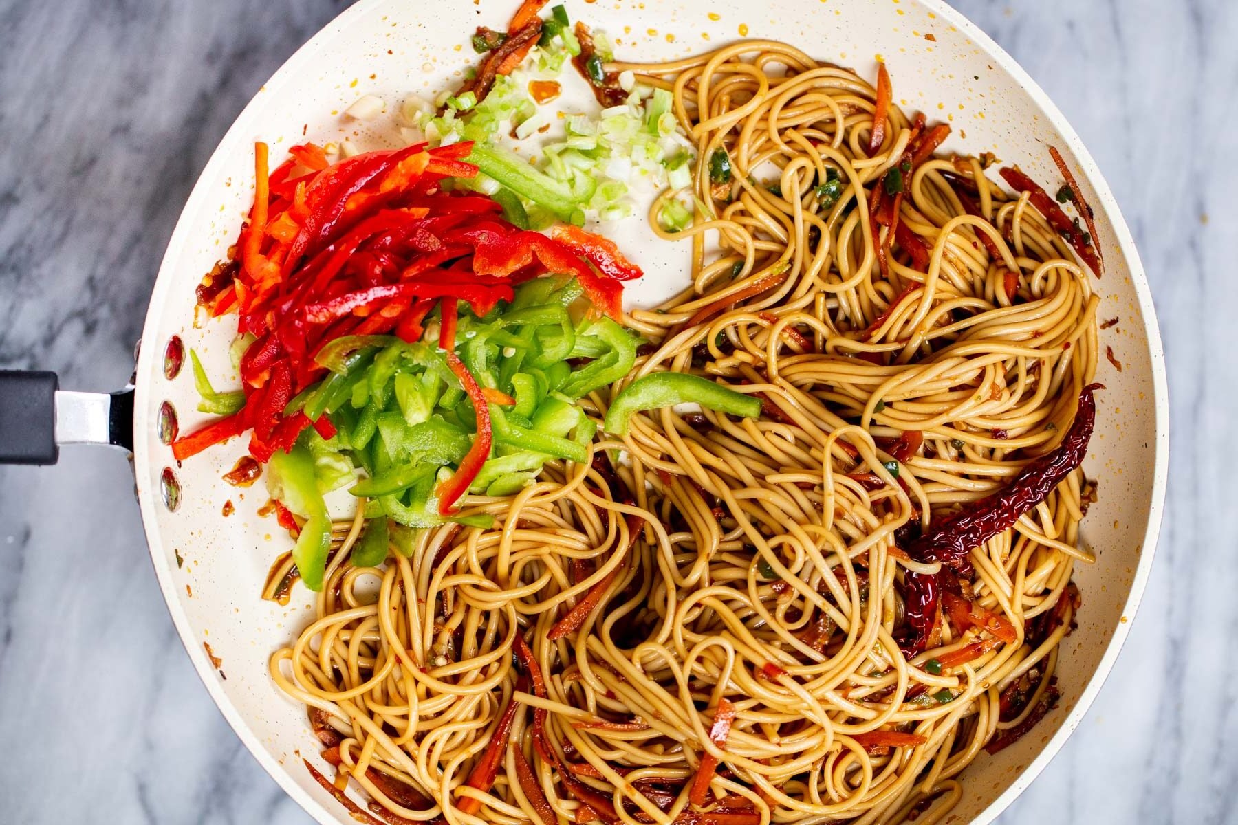 bell pepper being added to Indo Chinese Noodle Stir-fry.