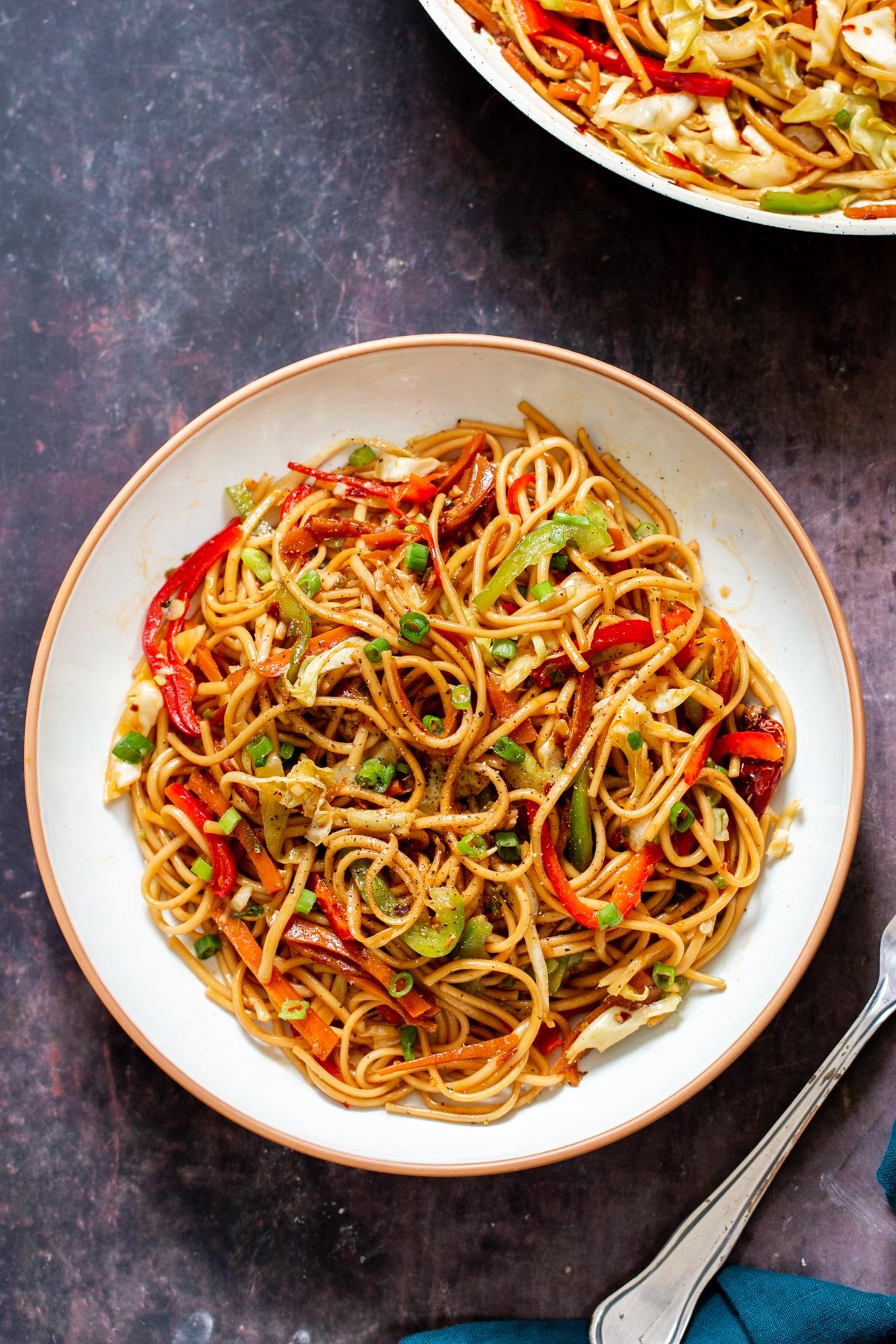 a plate of Indo Chinese Chilli Garlic Noodles topped with green onions