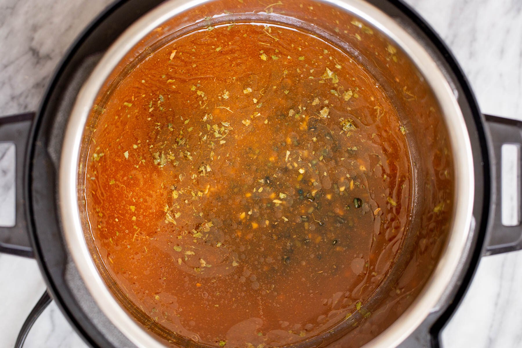 Black gram cooking with spices and tomato in an instant pot