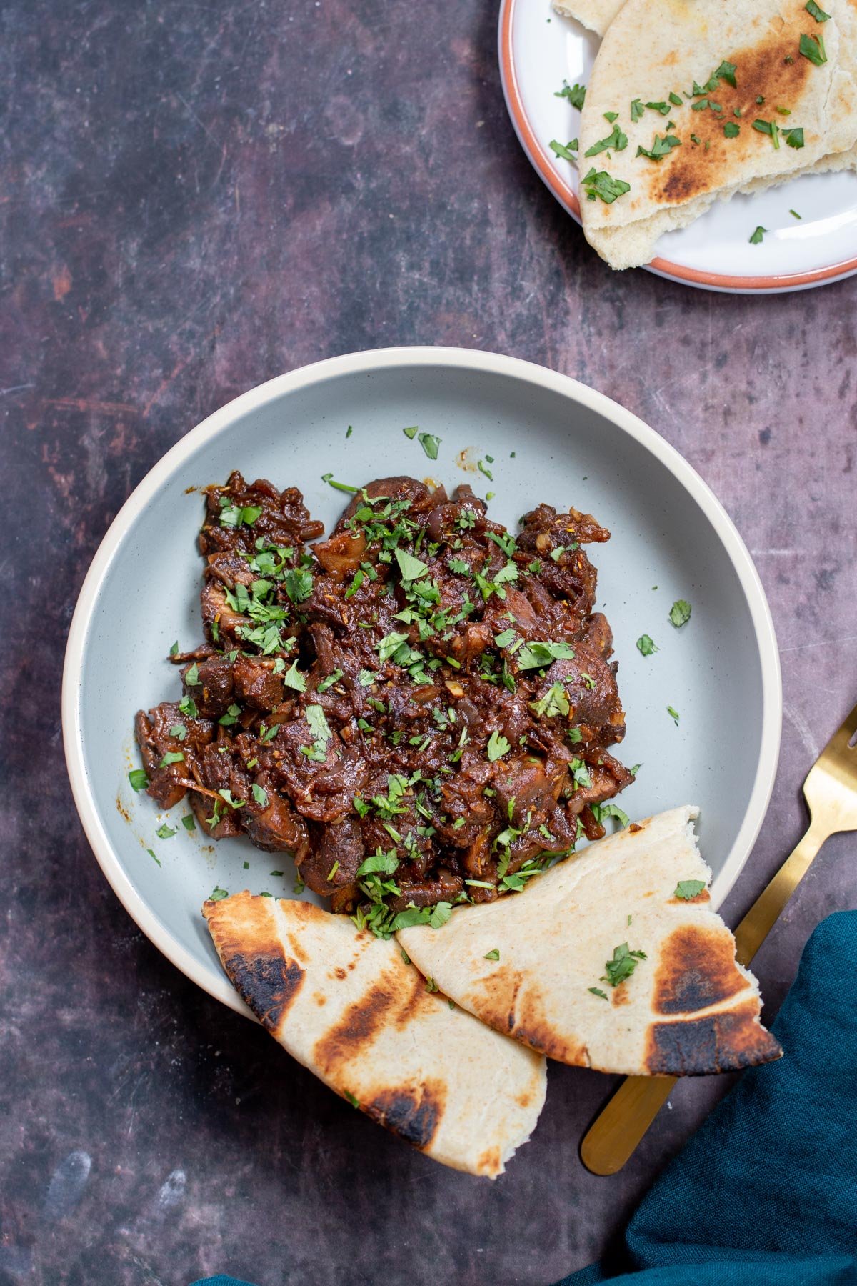 a plate of Ethiopian savory mushroom stir-fry served with a side of bread