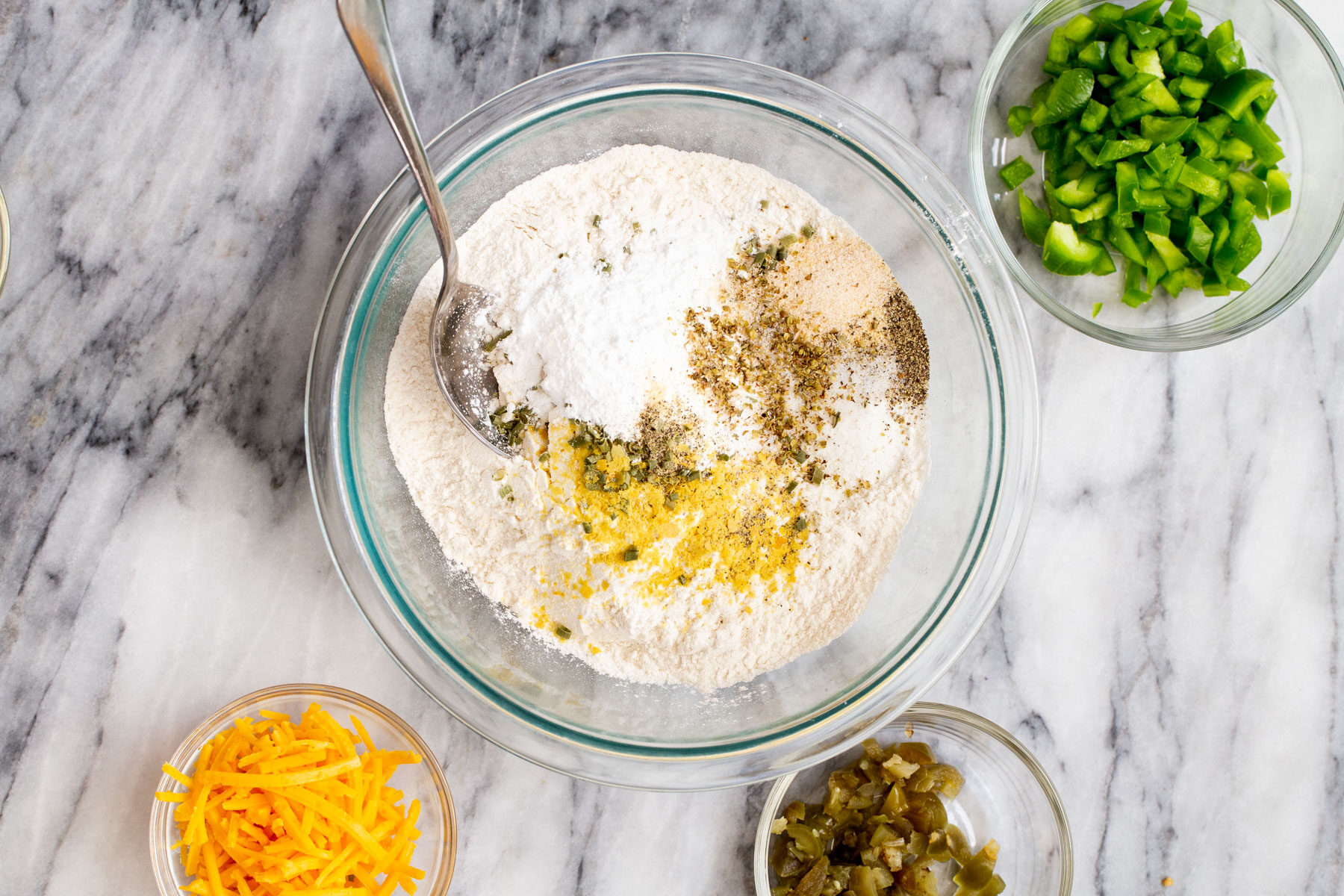 dry ingredients for vegan jalapeno waffles surrounded with add-in ingredients