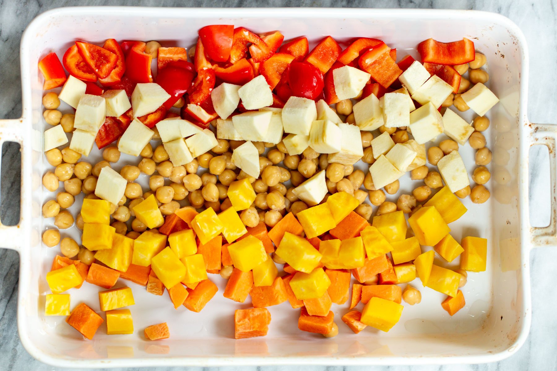 butternut squash, chickpeas and parsnips in a white casserole dish