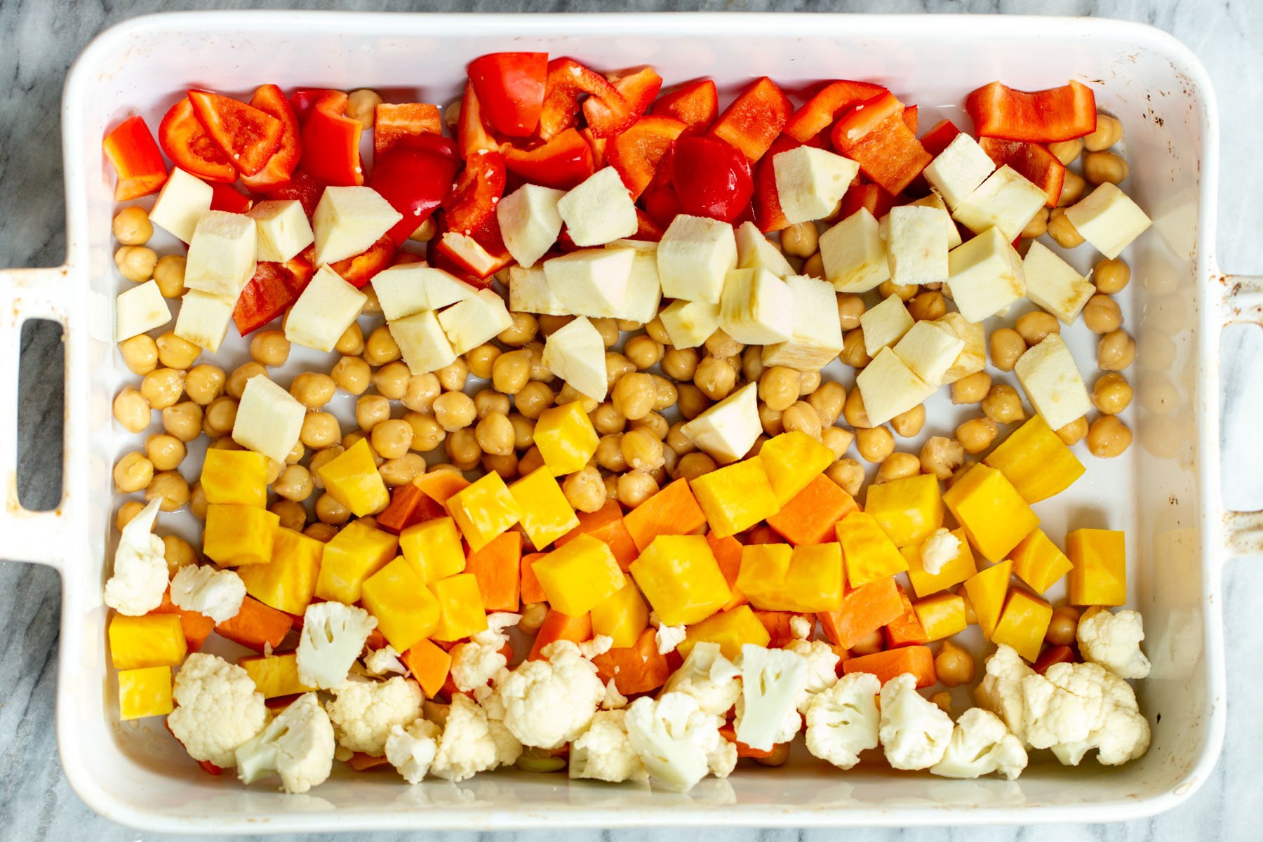 veggies arranged in a casserole dish according to color