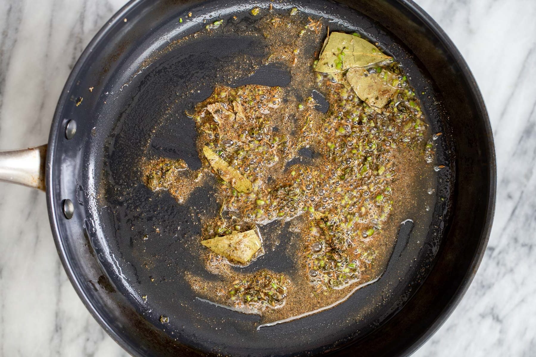 tempered spices in a sauteeing pan