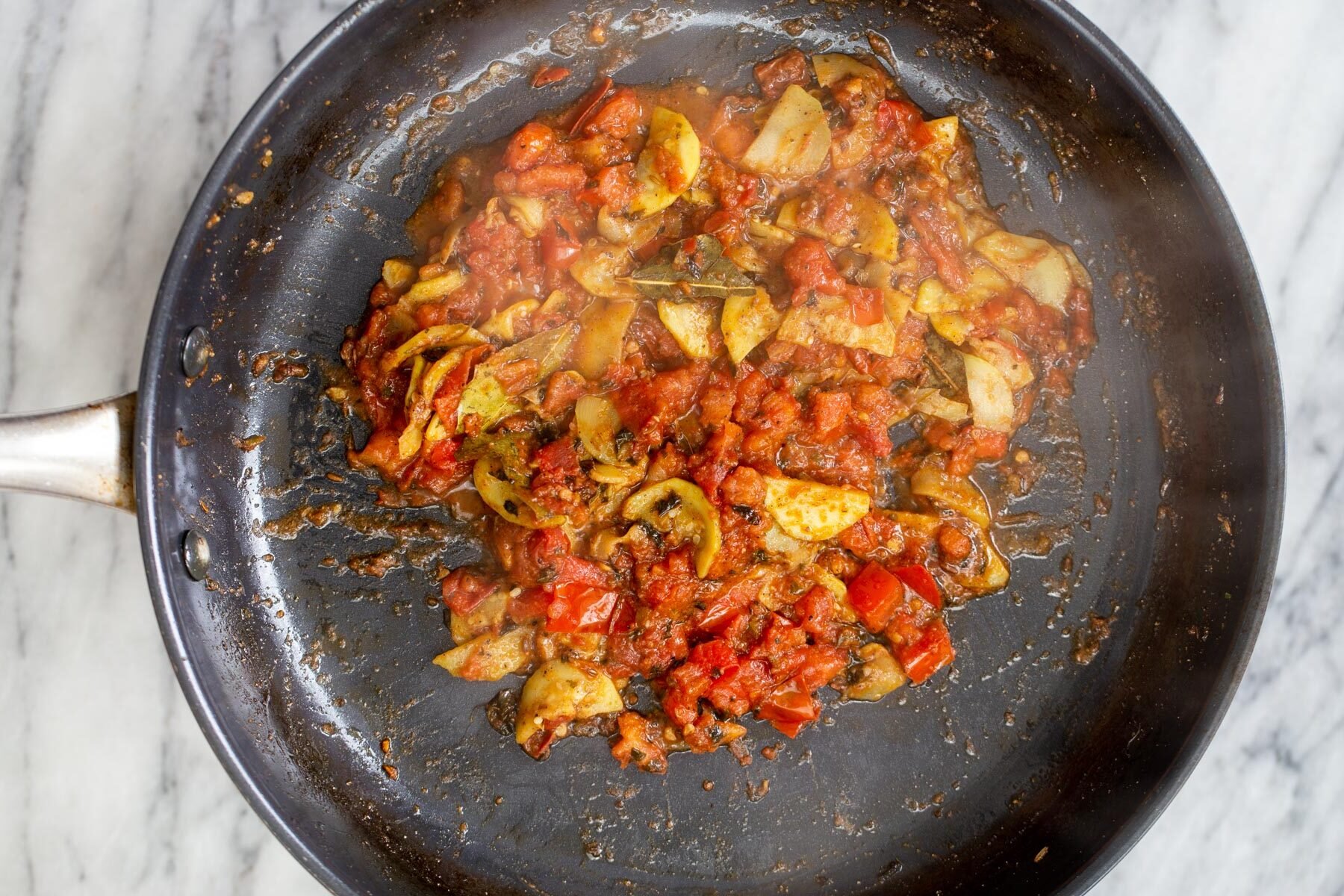 veggies in a black sauteeing pan