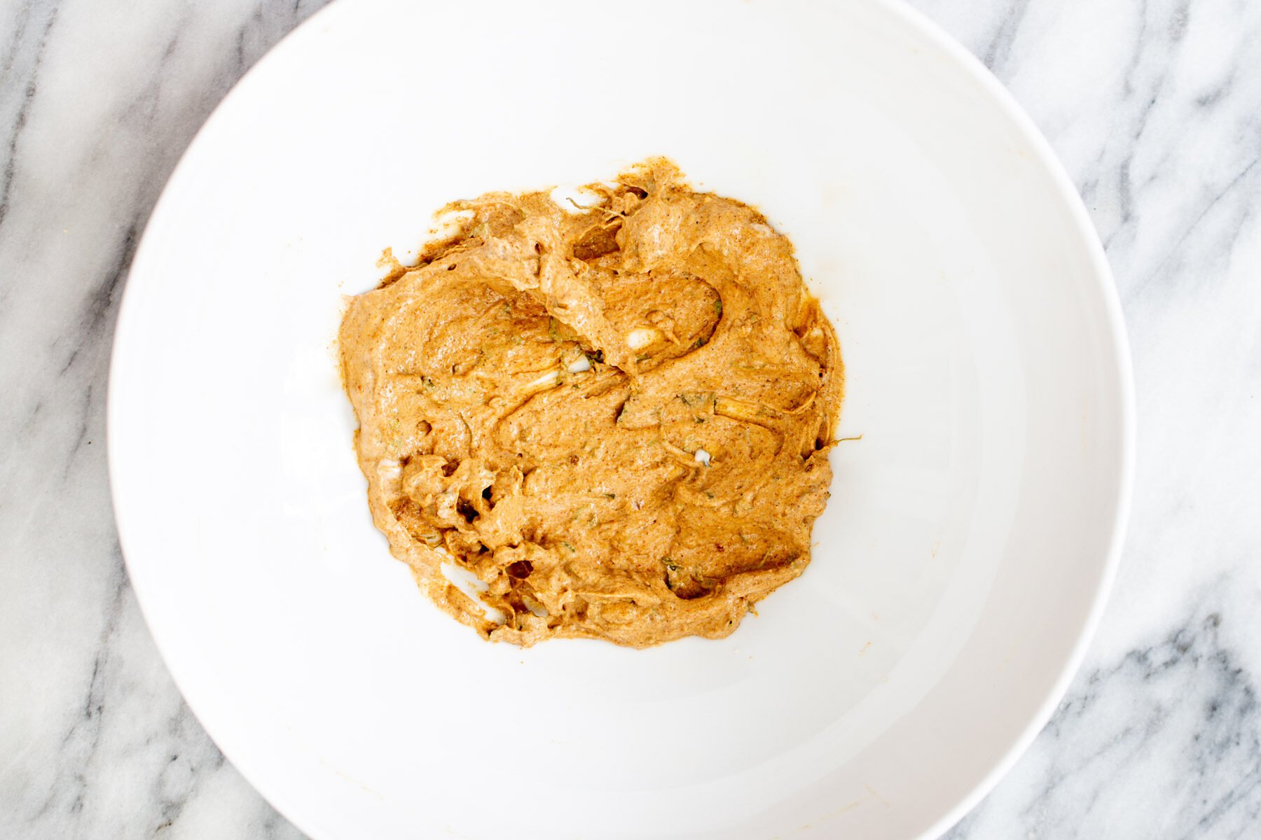 tofu tikka marinade in a small white bowl