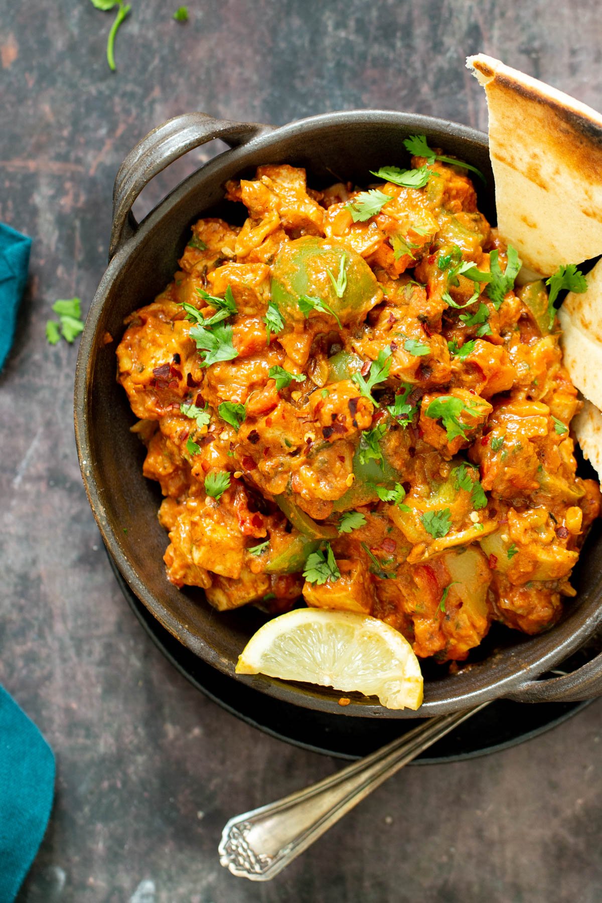 no onion no garlic tofu tikka masala in a small pot with flatbread