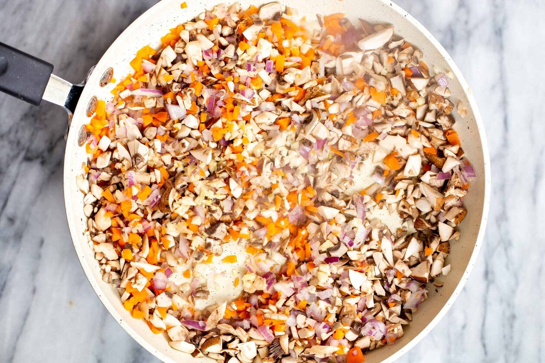 chopped veggies in a sauteeing pan