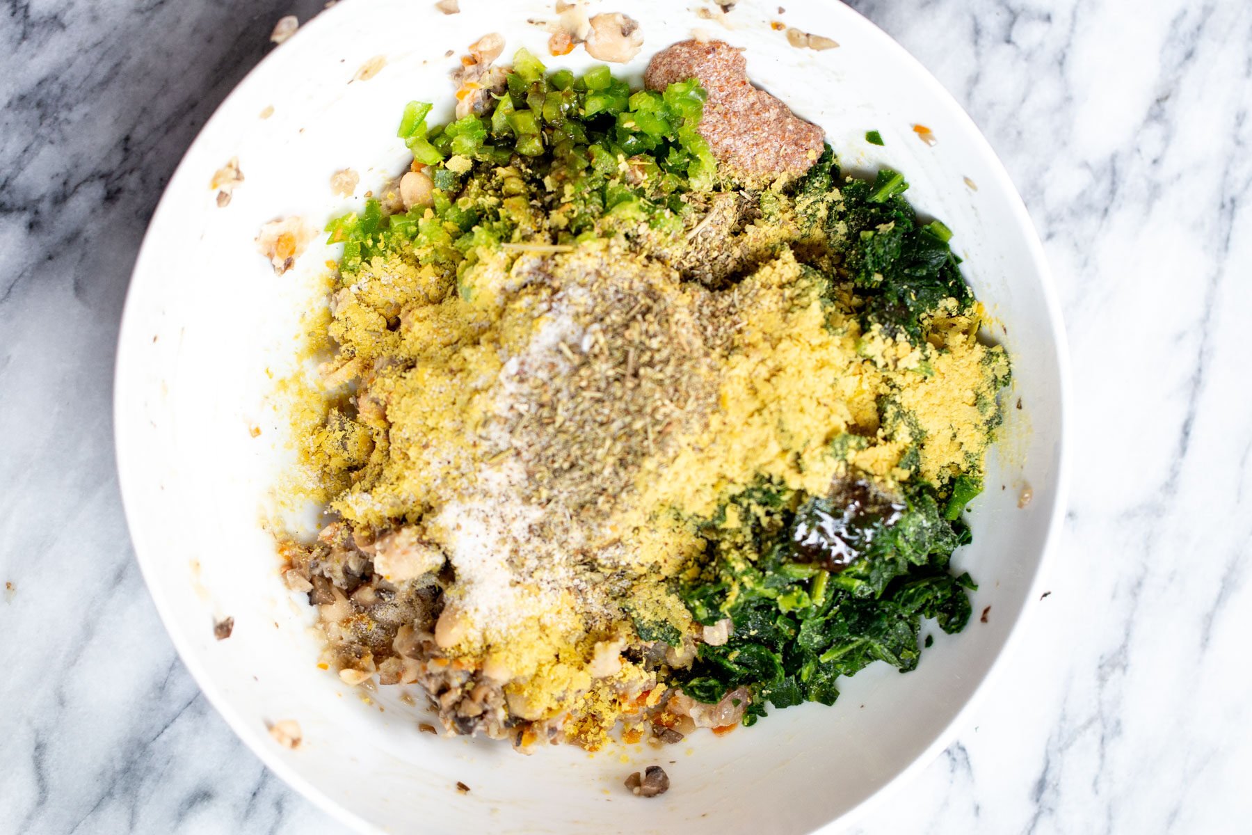 breadcrumbs being added to mushroom spinach filling