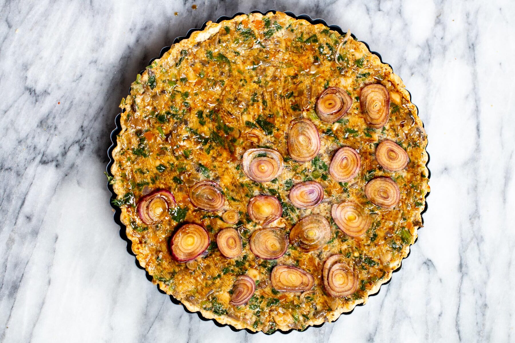 vegan quiche being glazed with worcestershire sauce