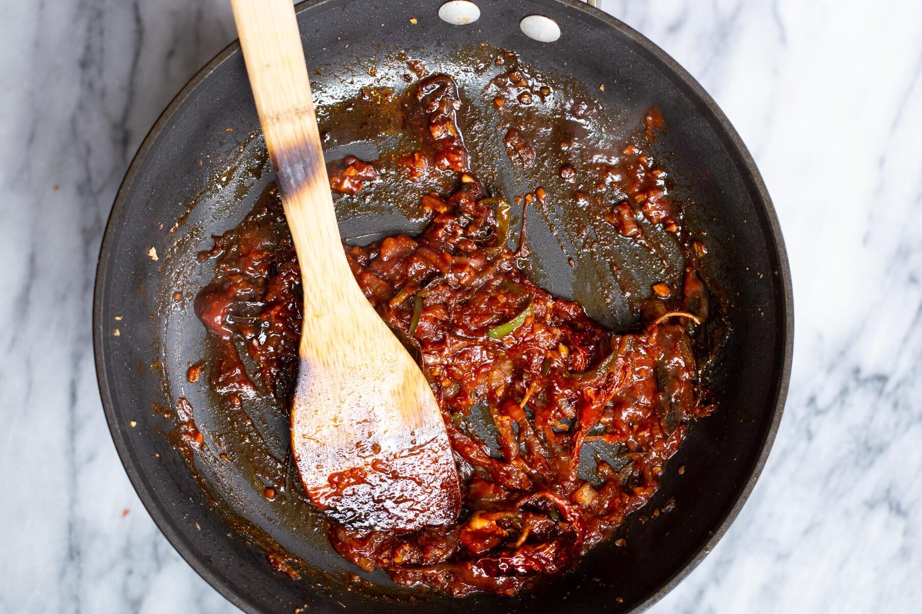 vegan chicken kondattam sauce in a black frying pan