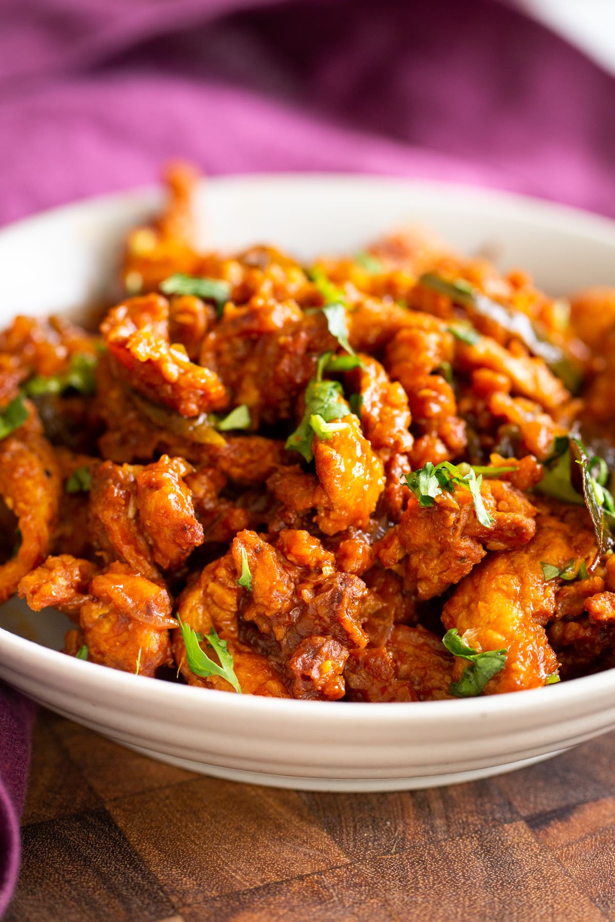 vegan chicken kondattam with soy curls in a small white bowl