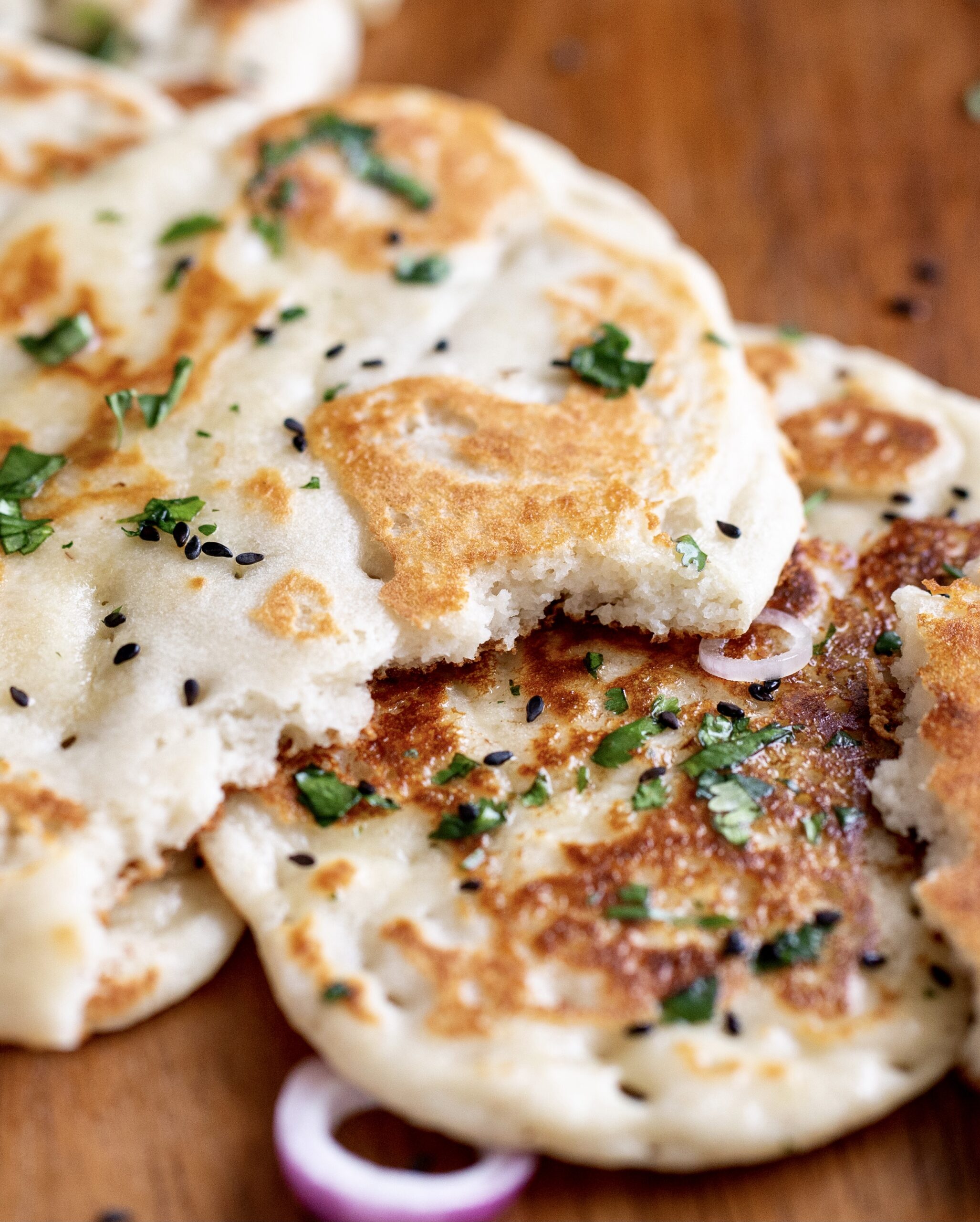 buttered almond flour naan on a chopping board