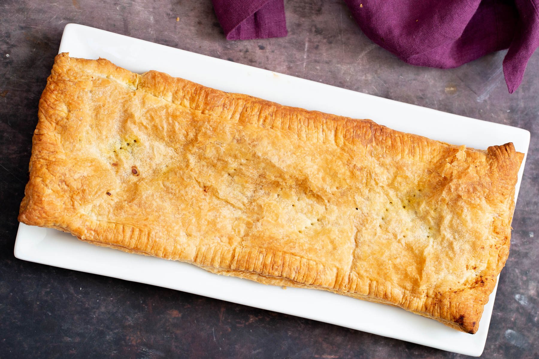 vegan sambusa pie with lentils filling cooling on a plate