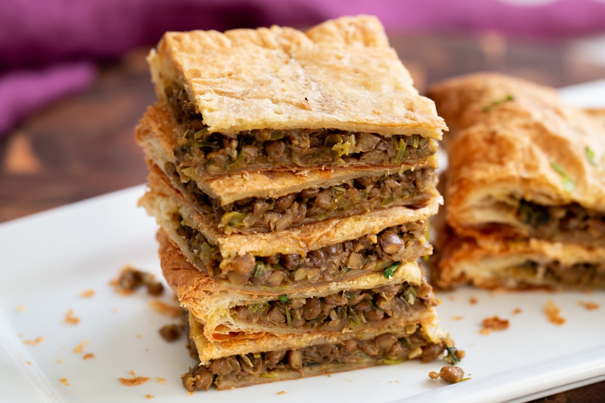 vegan sambusa pie  stacked slices of vegan lentil pie with puff pastry