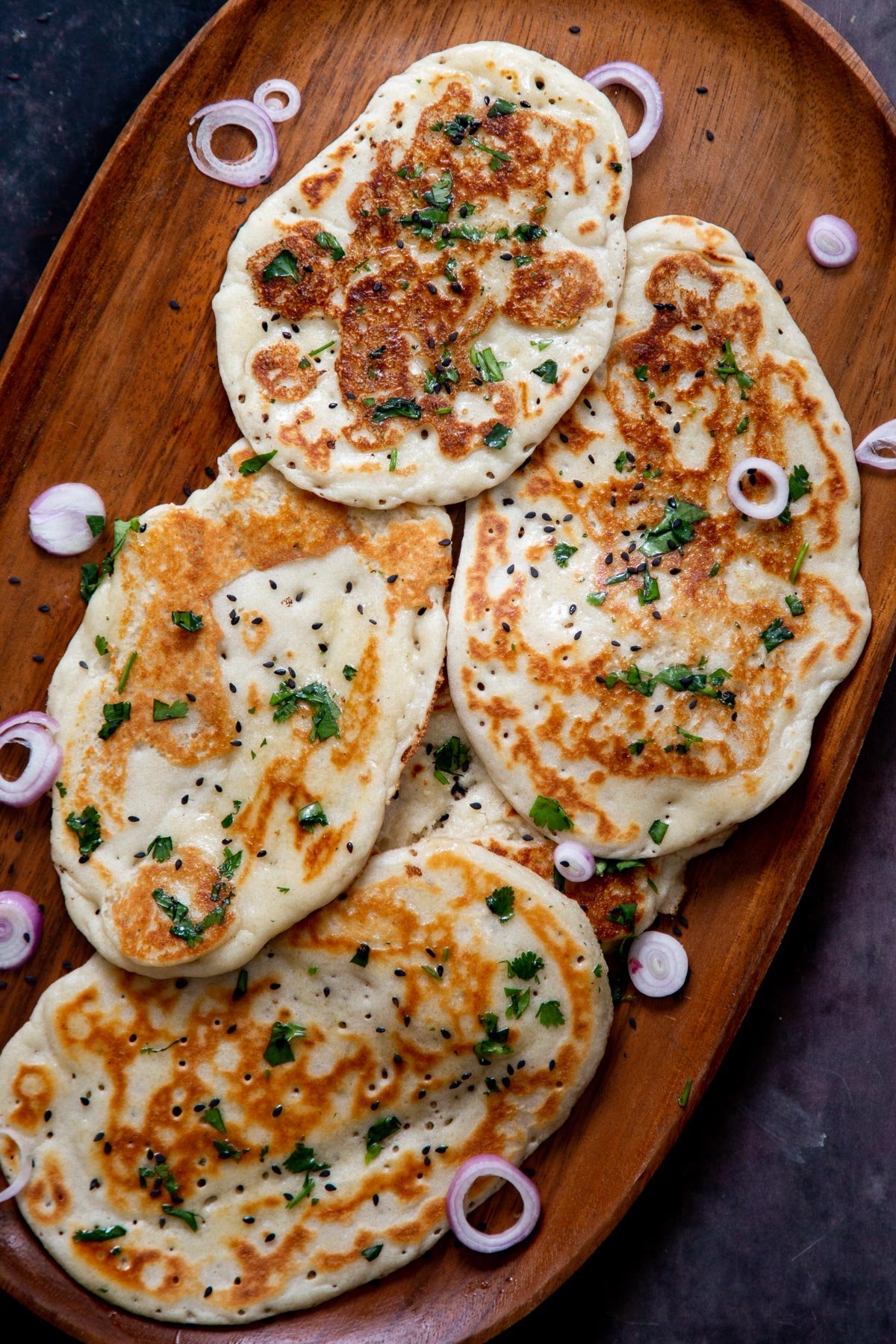 overhead shot if a wooden board with naan bread