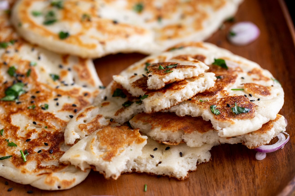 stacked vegan naan topped with cilantro
