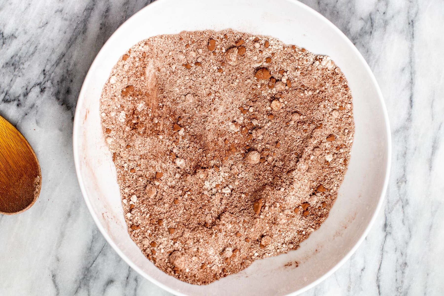 dry ingredients for peanut butter chocolate tarts in a white bowl 