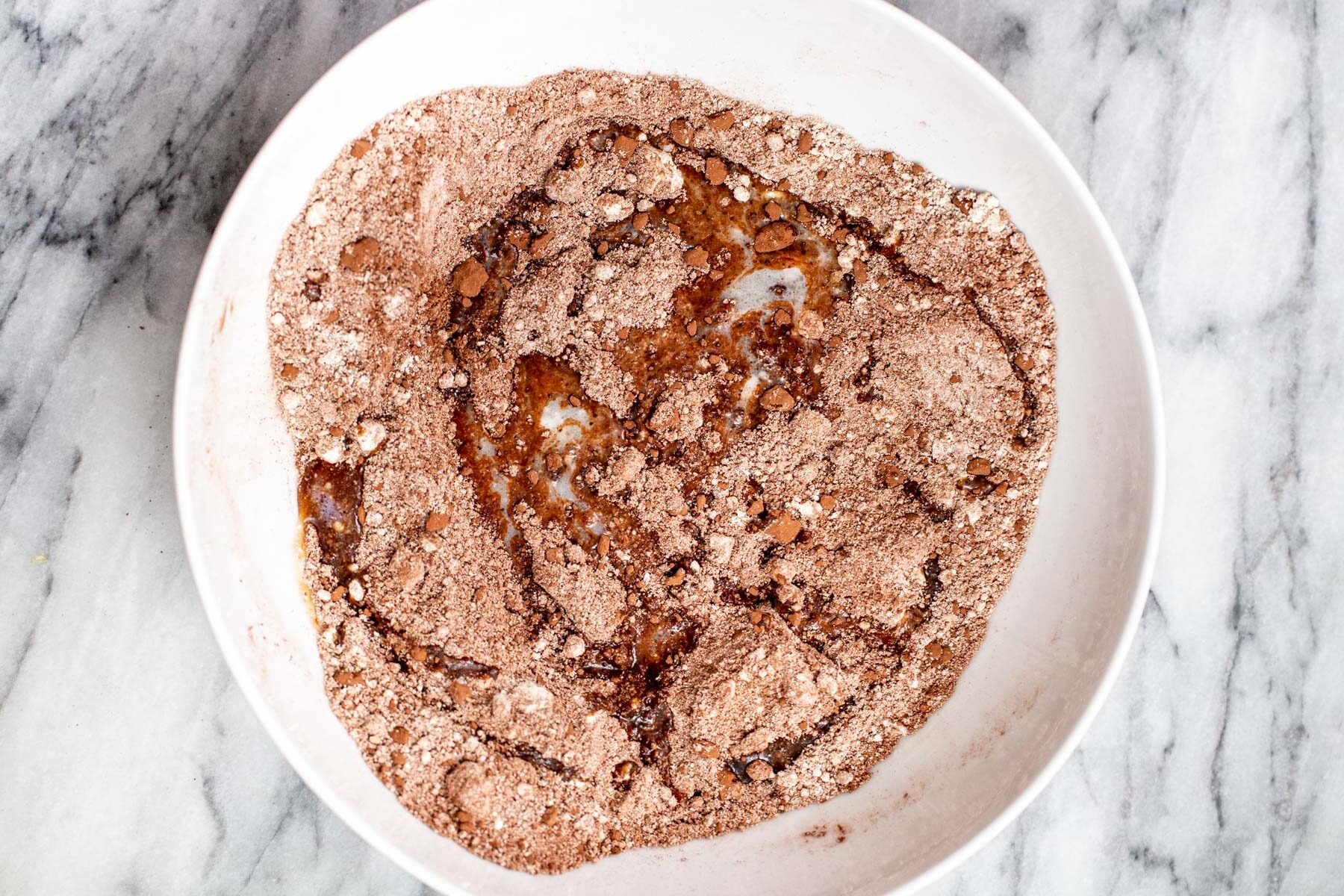 dry ingredients for peanut butter chocolate tart shell in a white bowl 