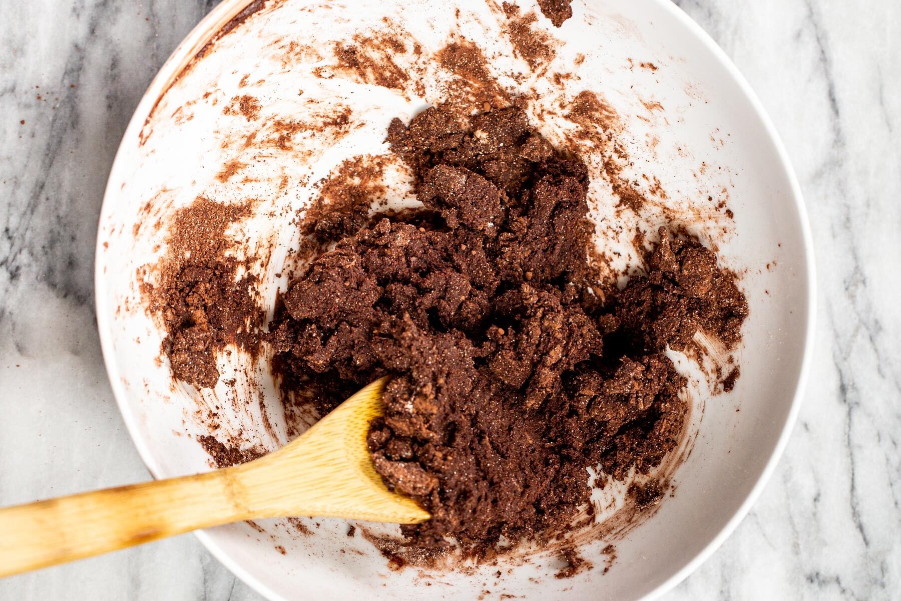 chocolate tart shell batter in a white bowl 
