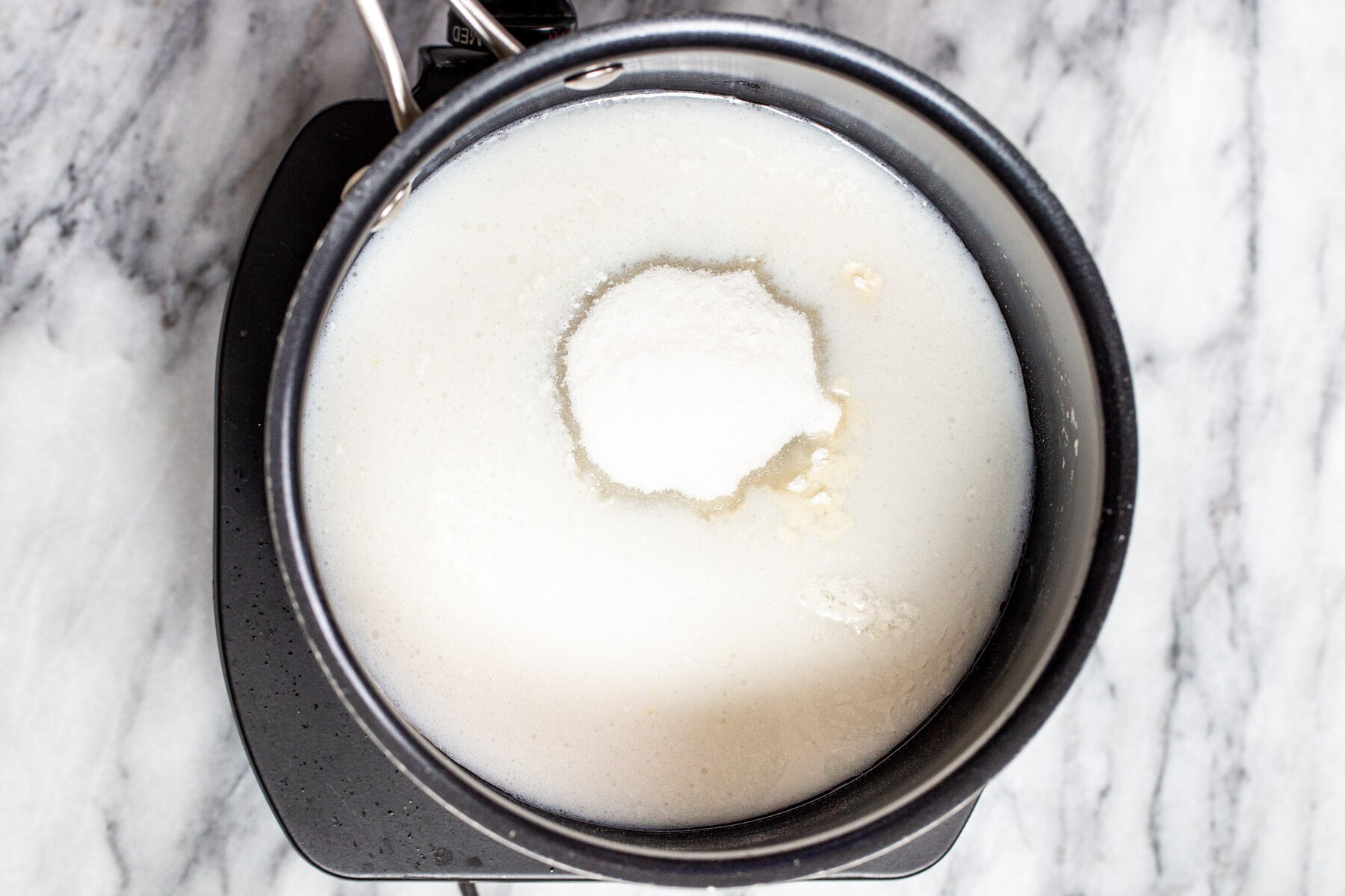 coconut milk and sugar in a small pot 