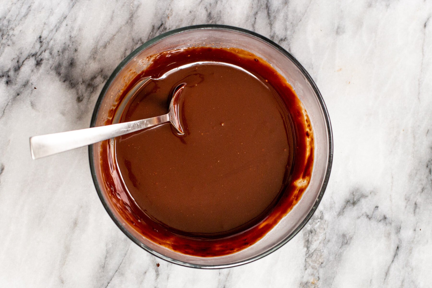chocolate glaze in a small glass bowl 