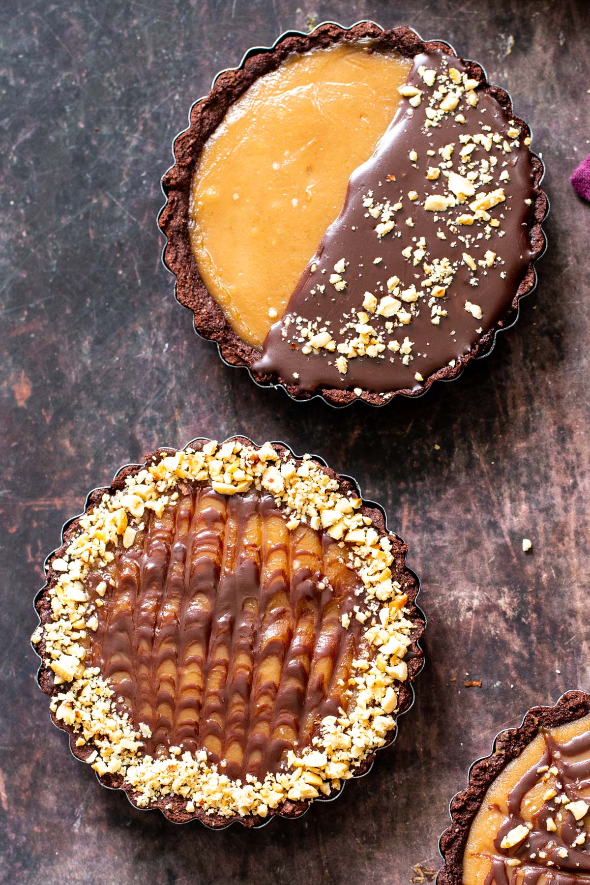 two small peanut butter chocolate tarts drizzled with chocolate
