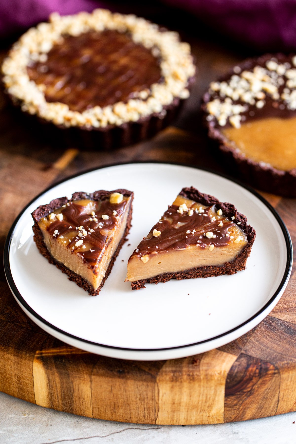 chocolate peanut butter tarts sliced on a white plate