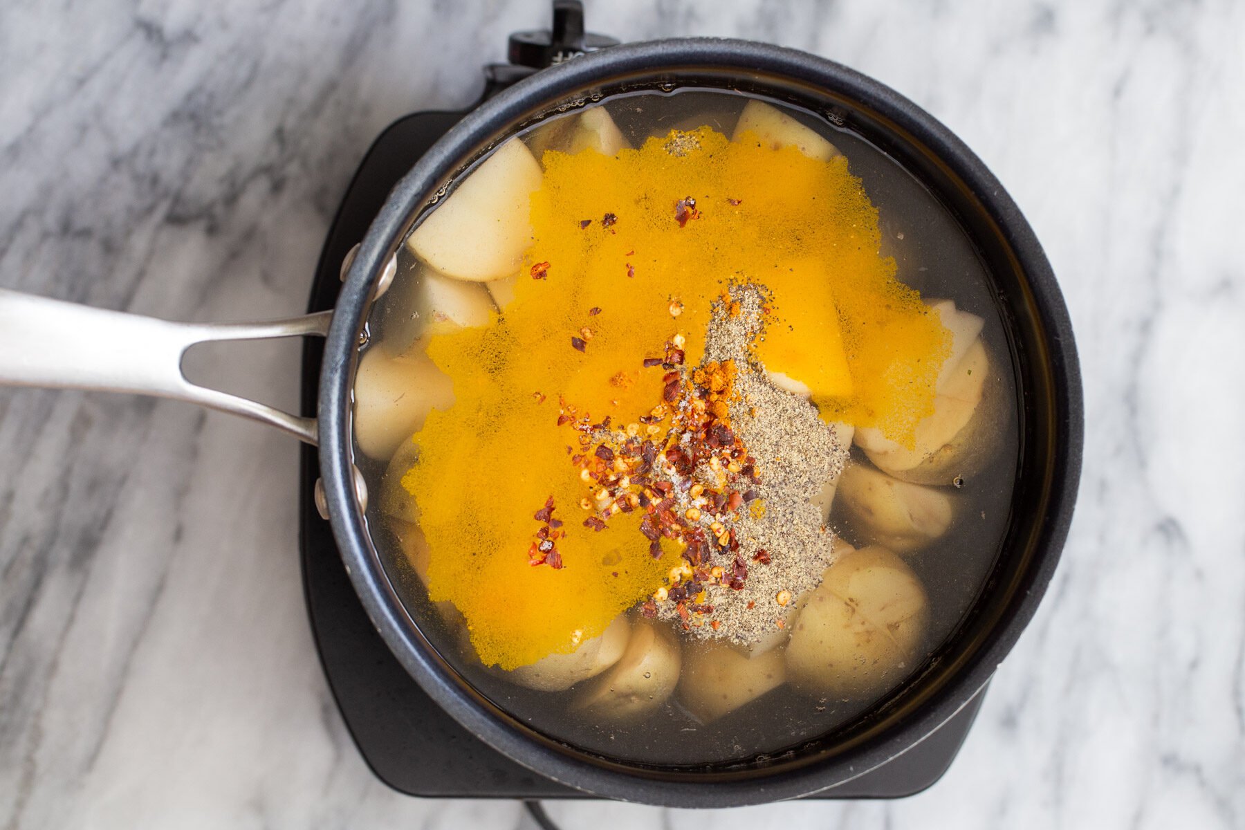 turmeric, black pepper and red pepper flakes in a pot