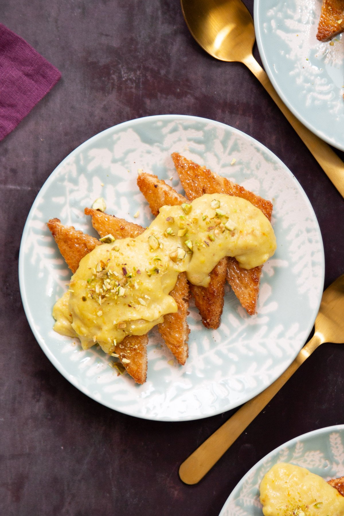 a plate of vegan toast soaked with syrup and covered with custard