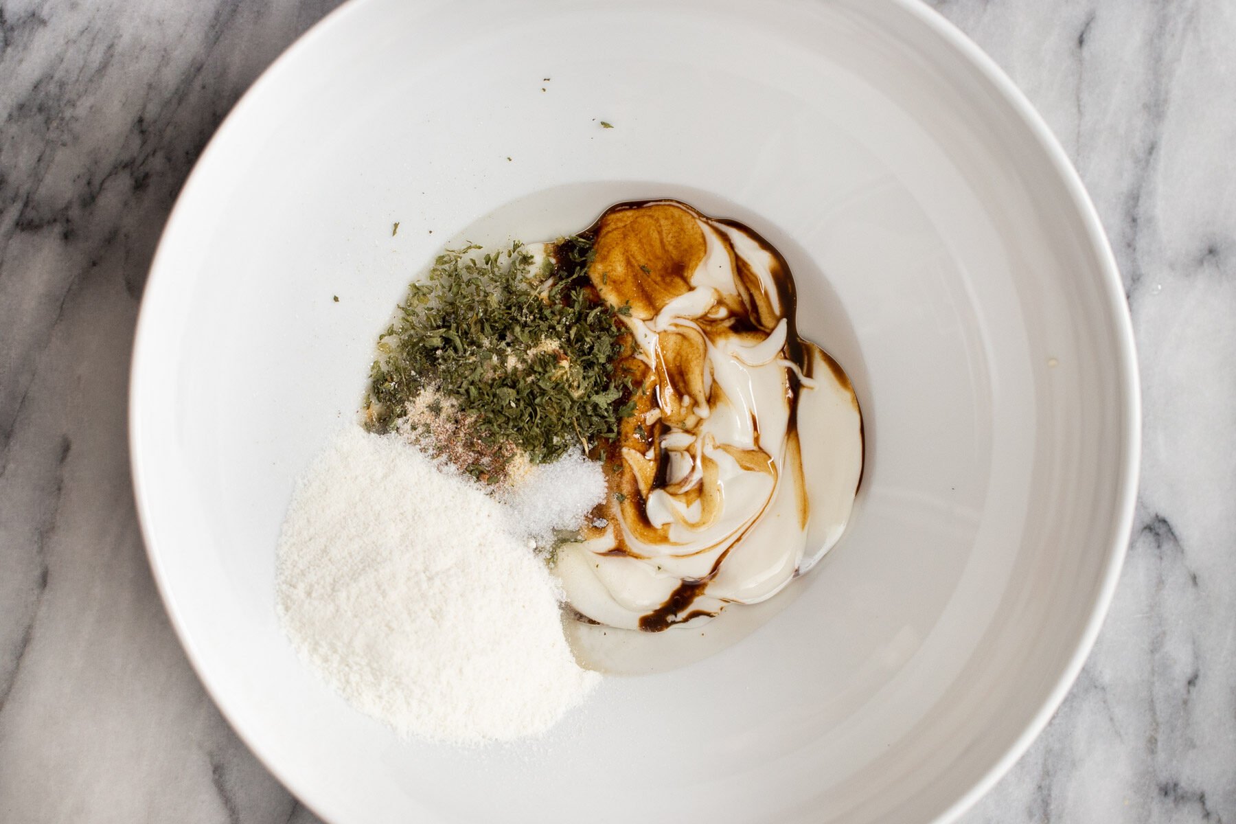 mushroom marinade ingredients in a white bowl