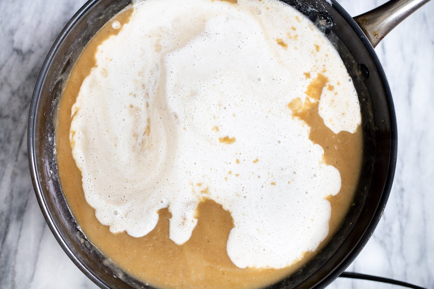 cashew milk being added to vegan mushroom gravy