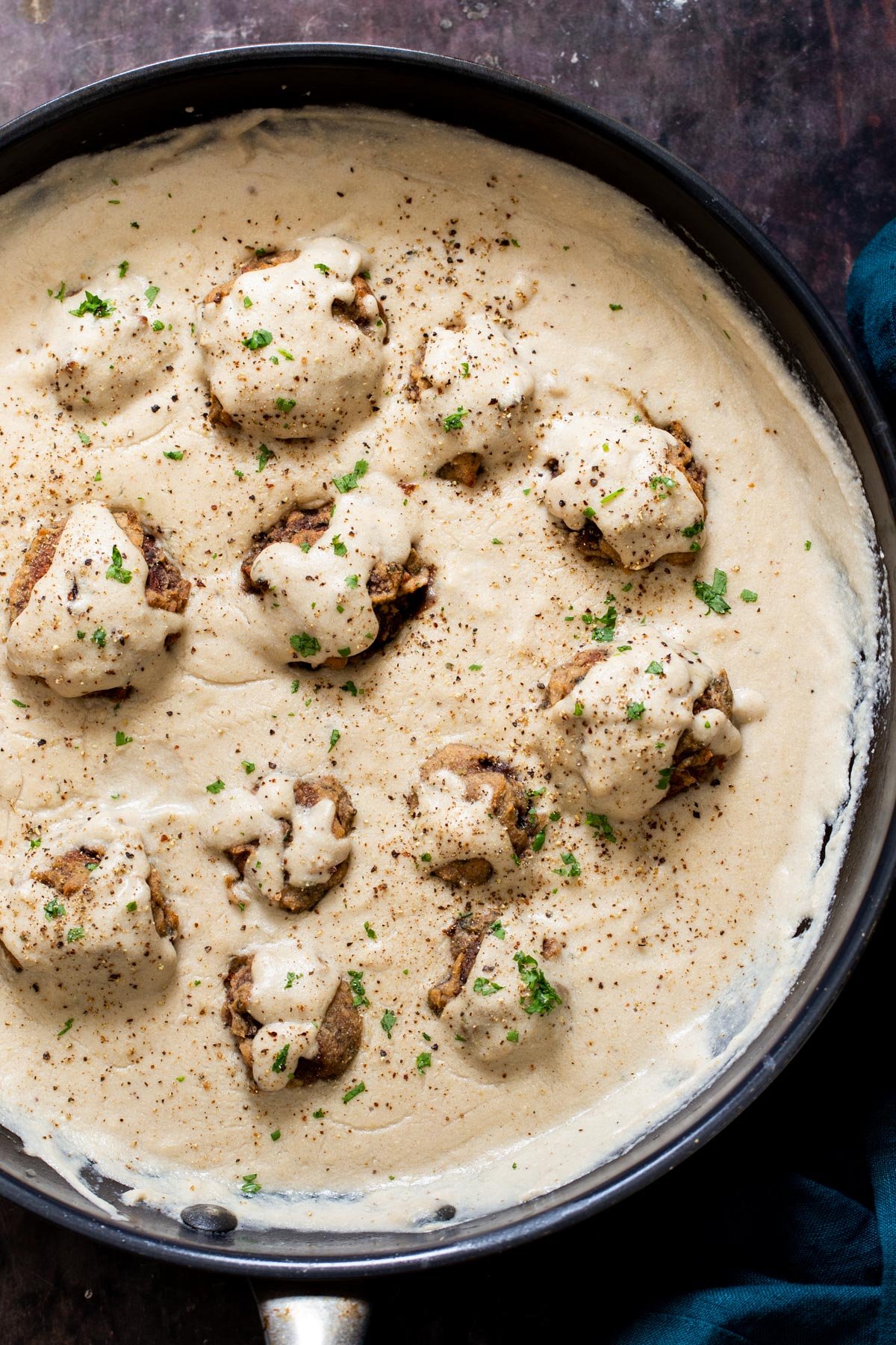 vegan mushroom. balls simmering in vegan gravy