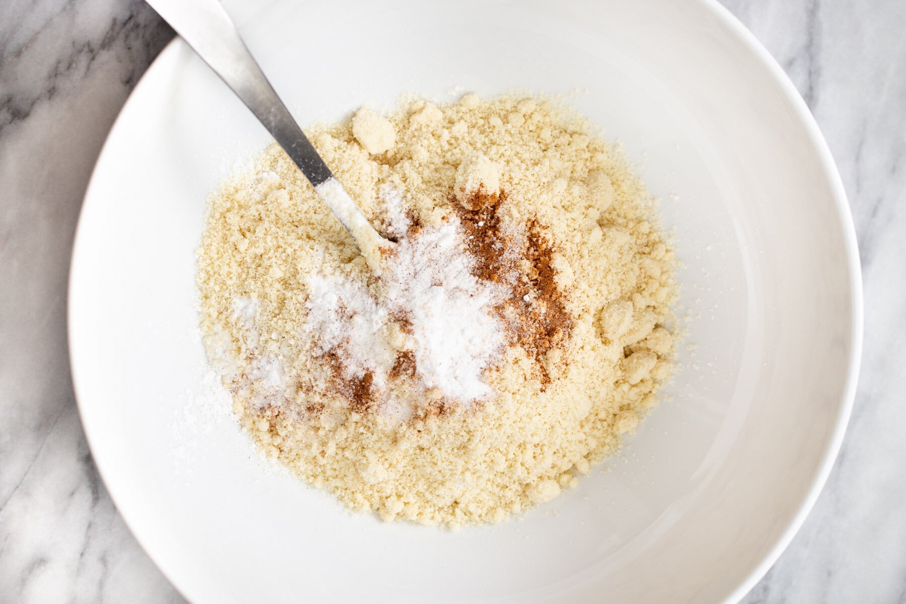 dry ingredients for vegan snickerdoodles in a white bowl
