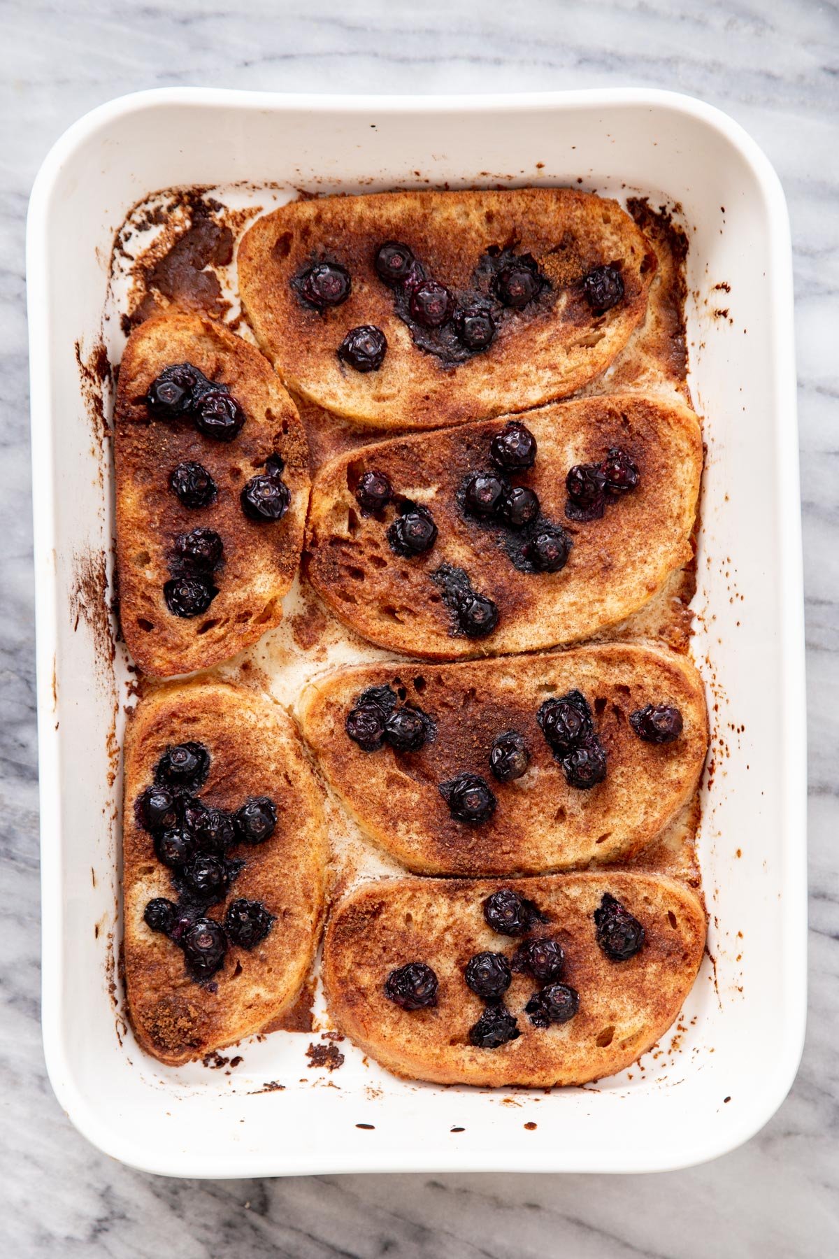 vegan baked French Toasts in a white casserole dish