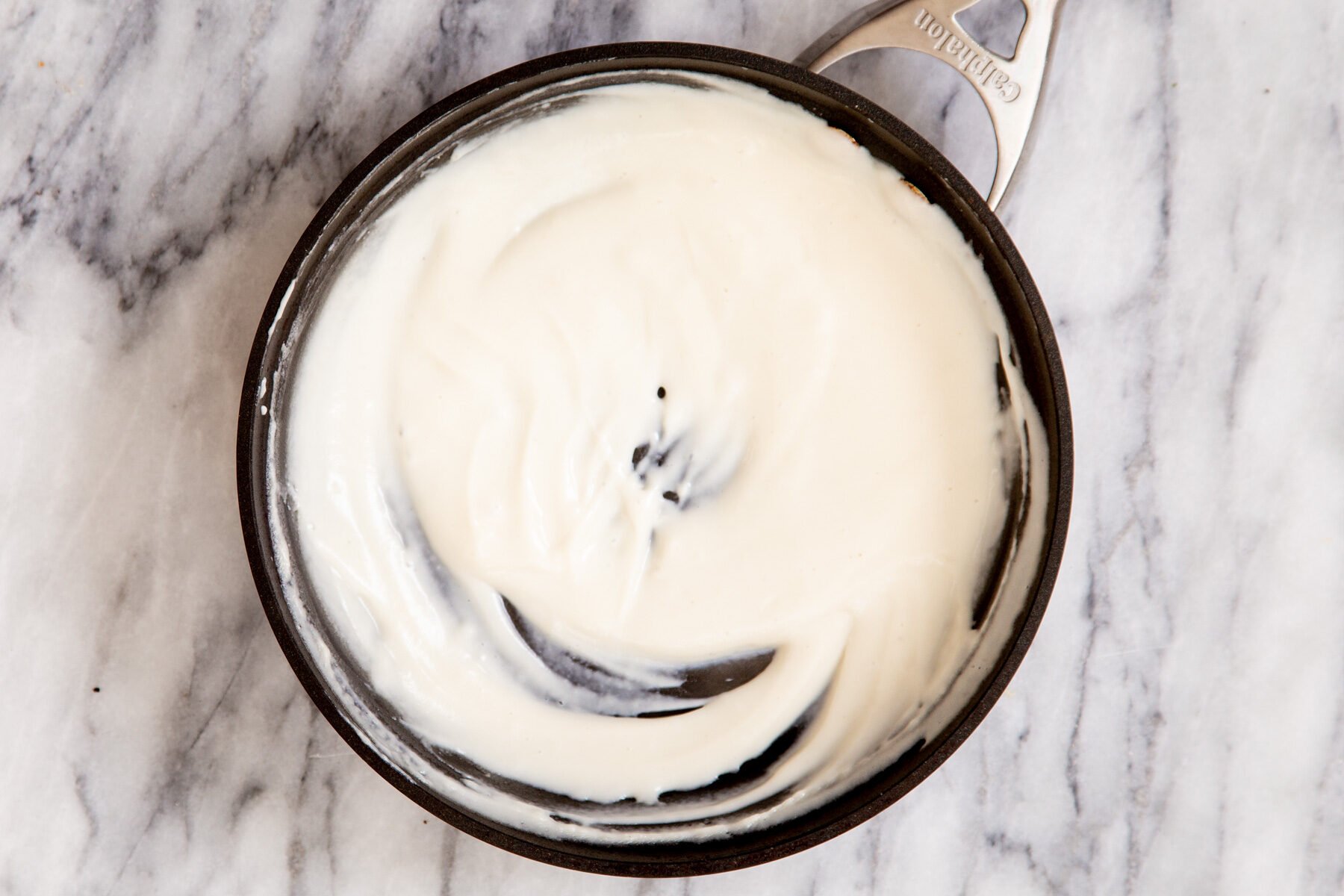 vegan cashew custard cooking in a small saucepan