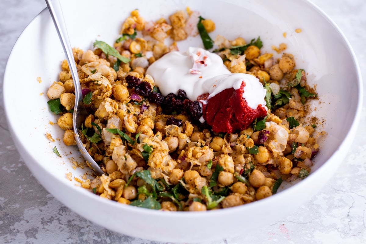 plant-based yogurt being mixed with mashed chickpeas and herbs