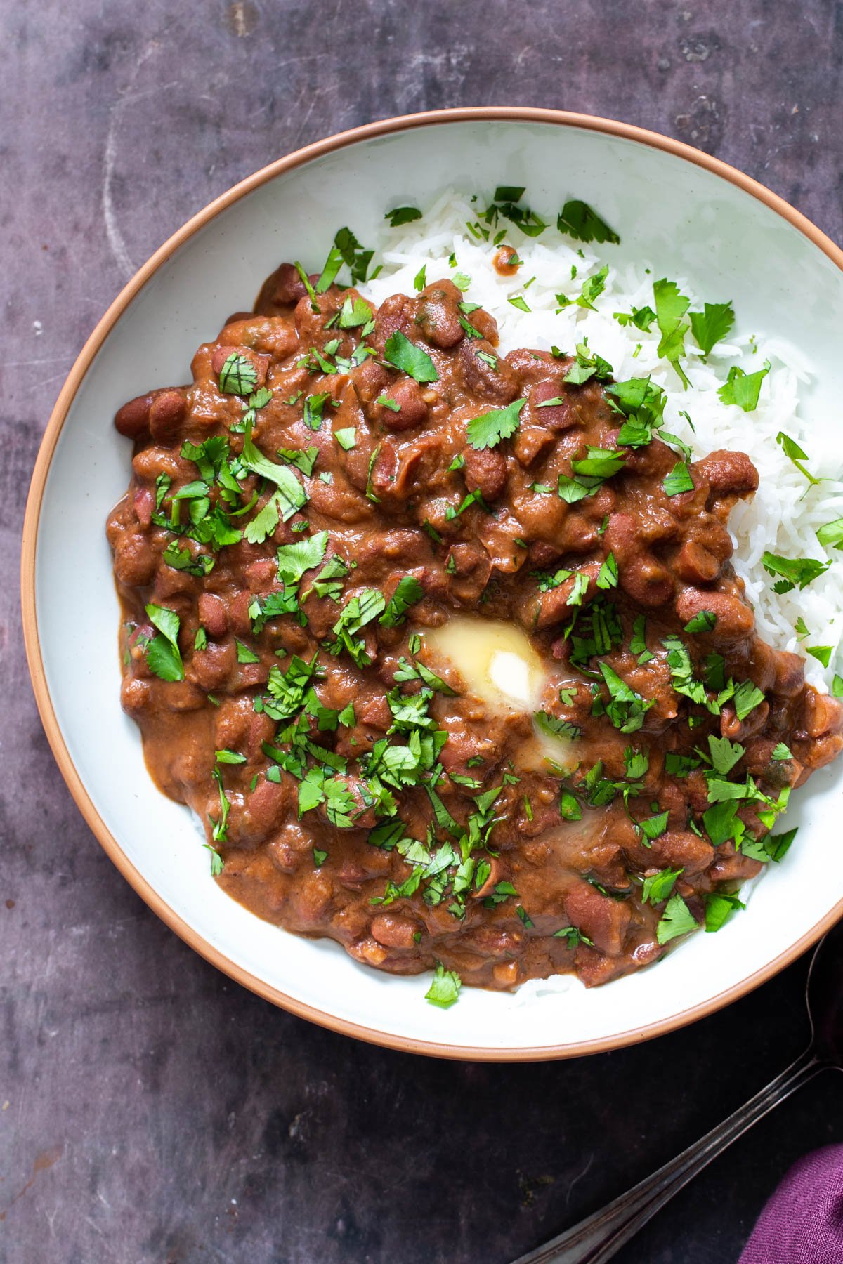 Indian Kidney Bean Curry a serving of Indian Dhaba Wake Rajma Curry served with a side of rice and topped with a dollop of butter