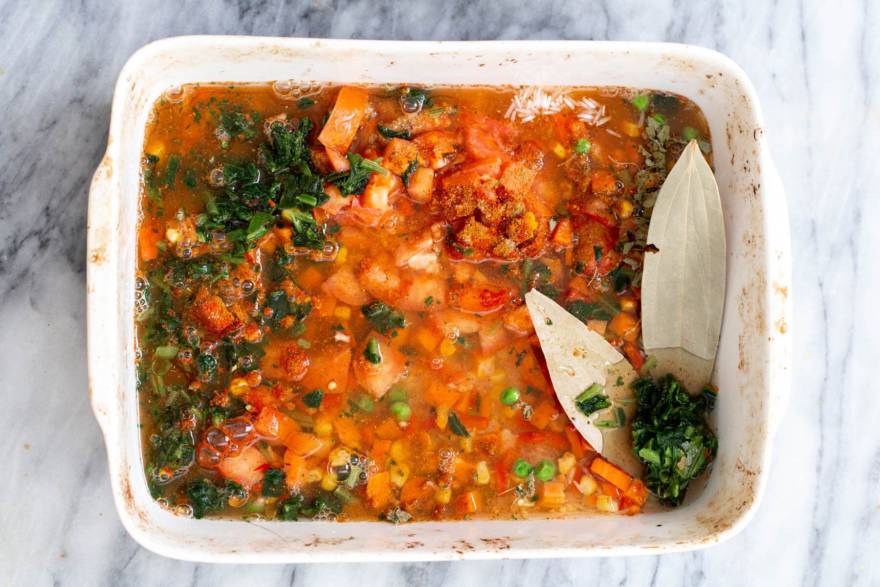 rice and vegetables cooking in a casserole dish